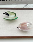 Add a touch of whimsy to your hairstyle with this pink swallow-shaped hair claw clip. Crafted from smooth acetate, it’s lightweight and easy to wear, bringing a playful, nature-inspired accent to everyday looks. Perfect for layering with other clips or wearing on its own for a charming, elegant finish.