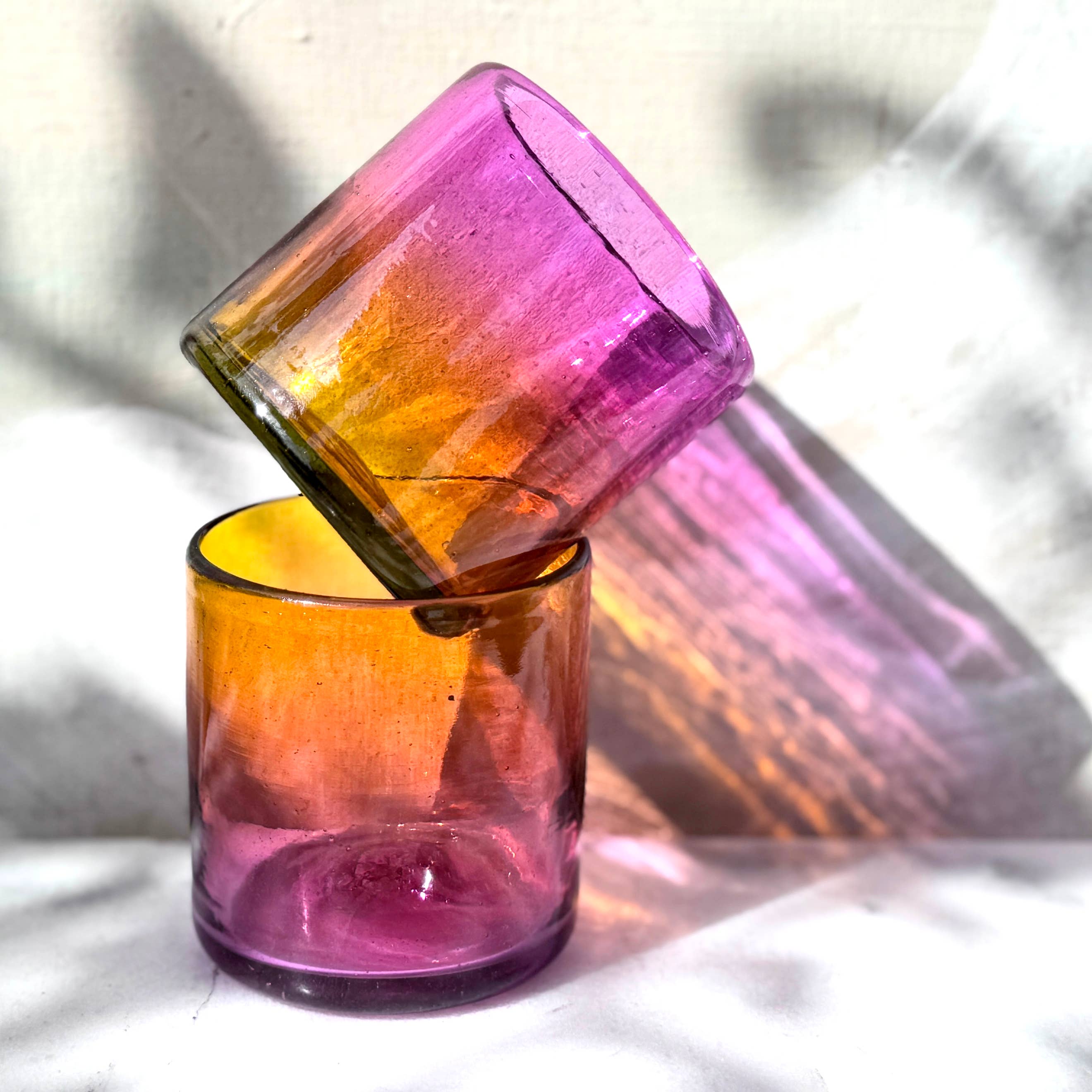 This vibrant, ombré pink and orange tumbler is hand blown in a family-run workshop, making each piece truly one-of-a-kind. Subtle variations in size and color mean no two are alike. Perfect for wine, cocktails, or even as a charming candle holder, it brings a touch of artistry and personality to any table.