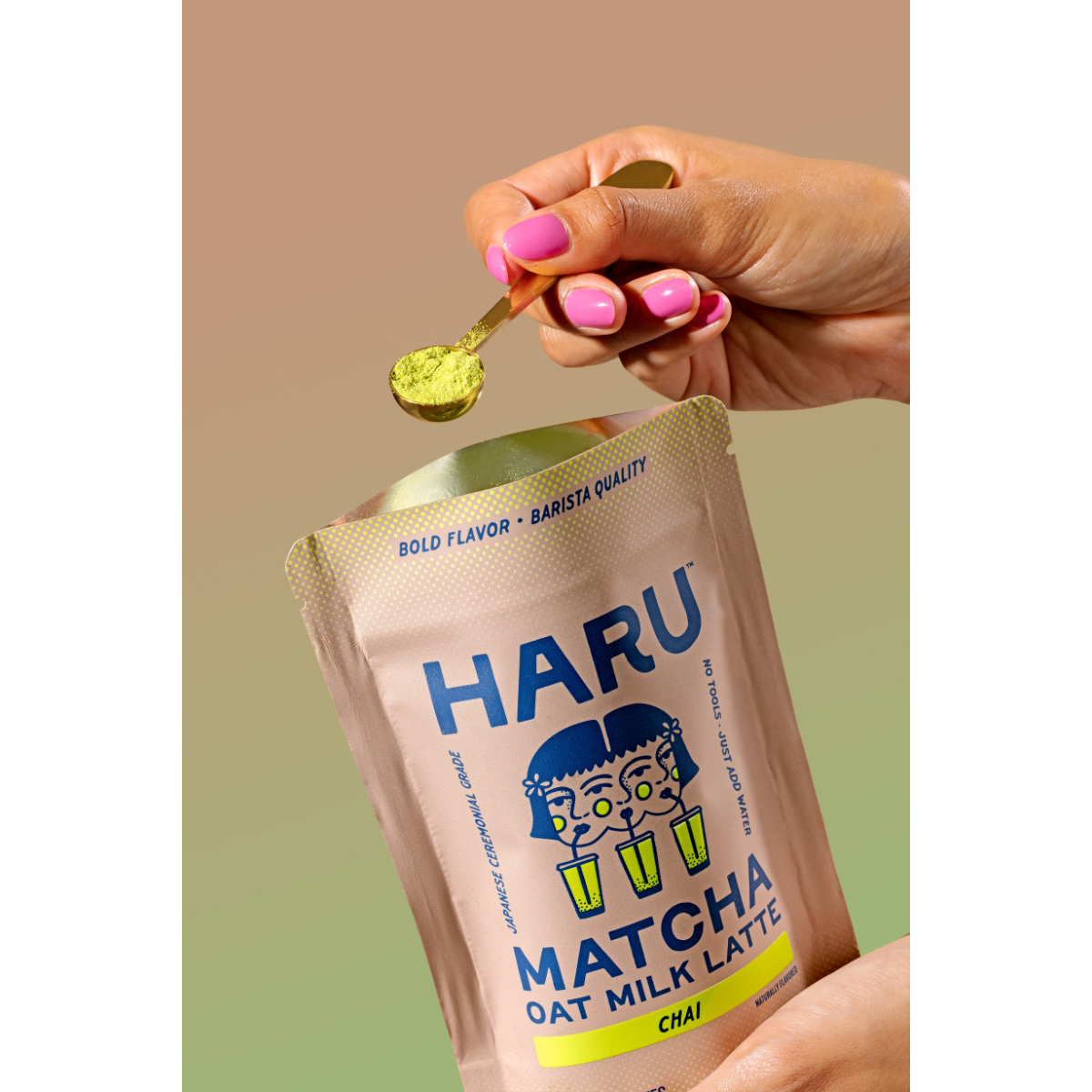 Hand holding a packet of HARU Matcha Oat Milk Latte with a spoonful of matcha powder.