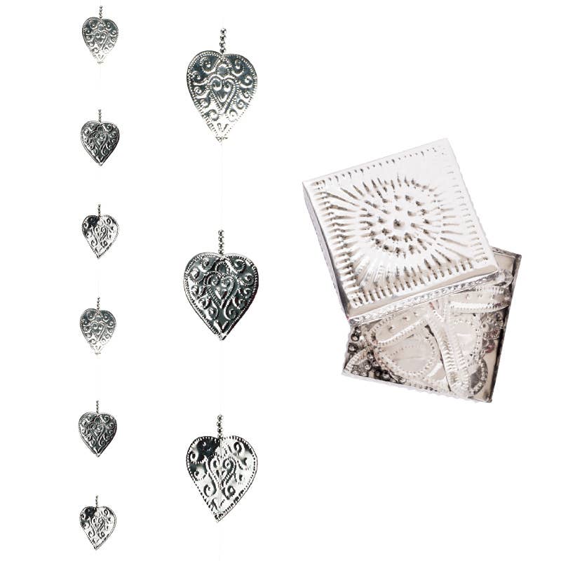 Delicate embossed silver hearts strung together on a dainty chain, this silver heart garland adds an elegant bohemian touch to any space. Perfect for Valentine's Day decor, wedding decorations, or everyday boho home decor, it's the kind of detail that makes a room feel curated and special. Comes packaged in a matching tin gift box, making it just as giftable as it is gorgeous.