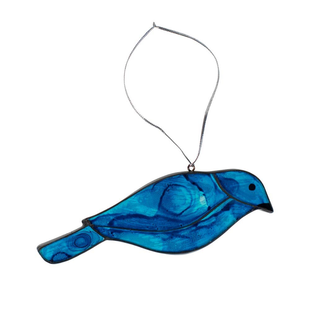 Bring a touch of charm and cheer to your holiday décor with the Glass Bluebird Ornament—a delicate, handcrafted piece that’s perfect for bird lovers and nature enthusiasts alike.

Made by skilled artisans, each ornament is carefully made by hand, capturing the joyful spirit of the bluebird in shimmering glass. Whether it’s perched on a tree branch or tied to a gift box as a sweet finishing touch, this ornament adds a thoughtful, meaningful accent to your holiday traditions.
