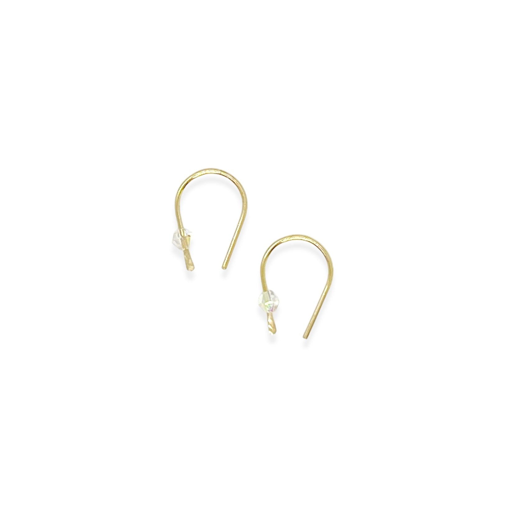 Simple and expressive, the Horseshoe Pull-Through Hoops are a fresh take on everyday earrings. Their petite arc shape hugs the lobe just right, while a single crystal adds a glint of light and intention. Minimal yet full of meaning, these are the earrings you’ll reach for again and again.
