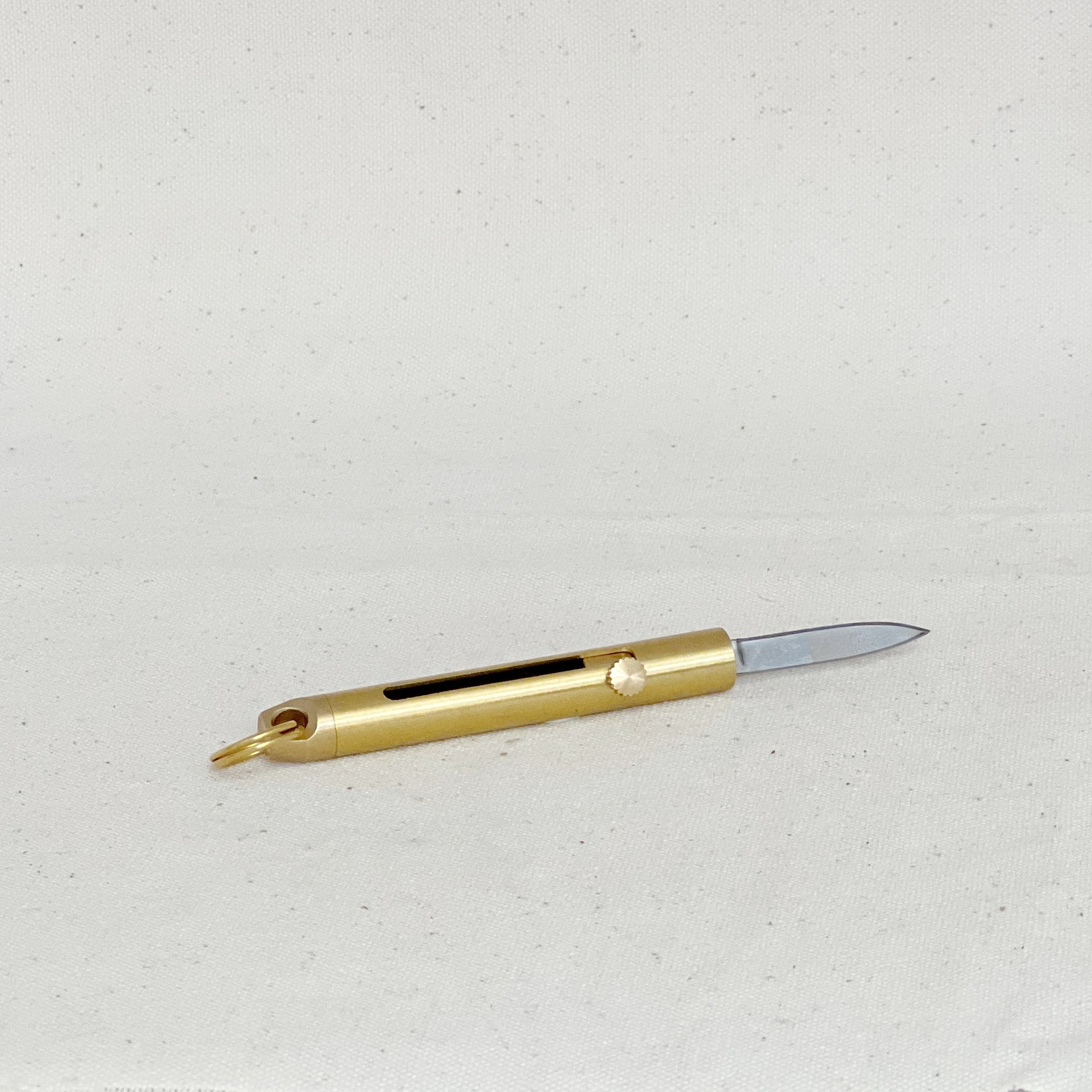 This brass mini folding knife is a compact, stylish EDC essential with a precision blade, smooth sliding mechanism, and timeless design. Durable and versatile.