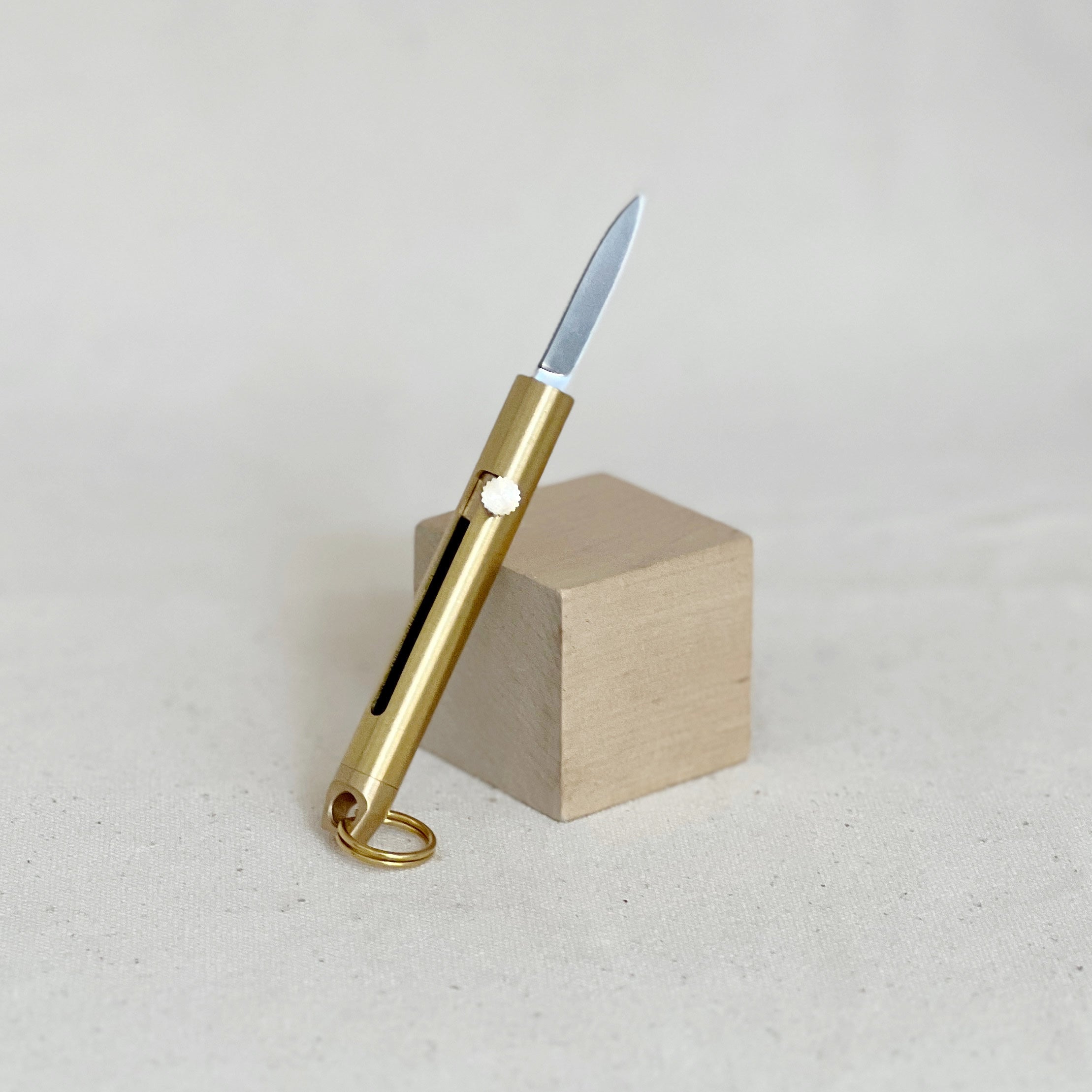 This brass mini folding knife is a compact, stylish EDC essential with a precision blade, smooth sliding mechanism, and timeless design. Durable and versatile.