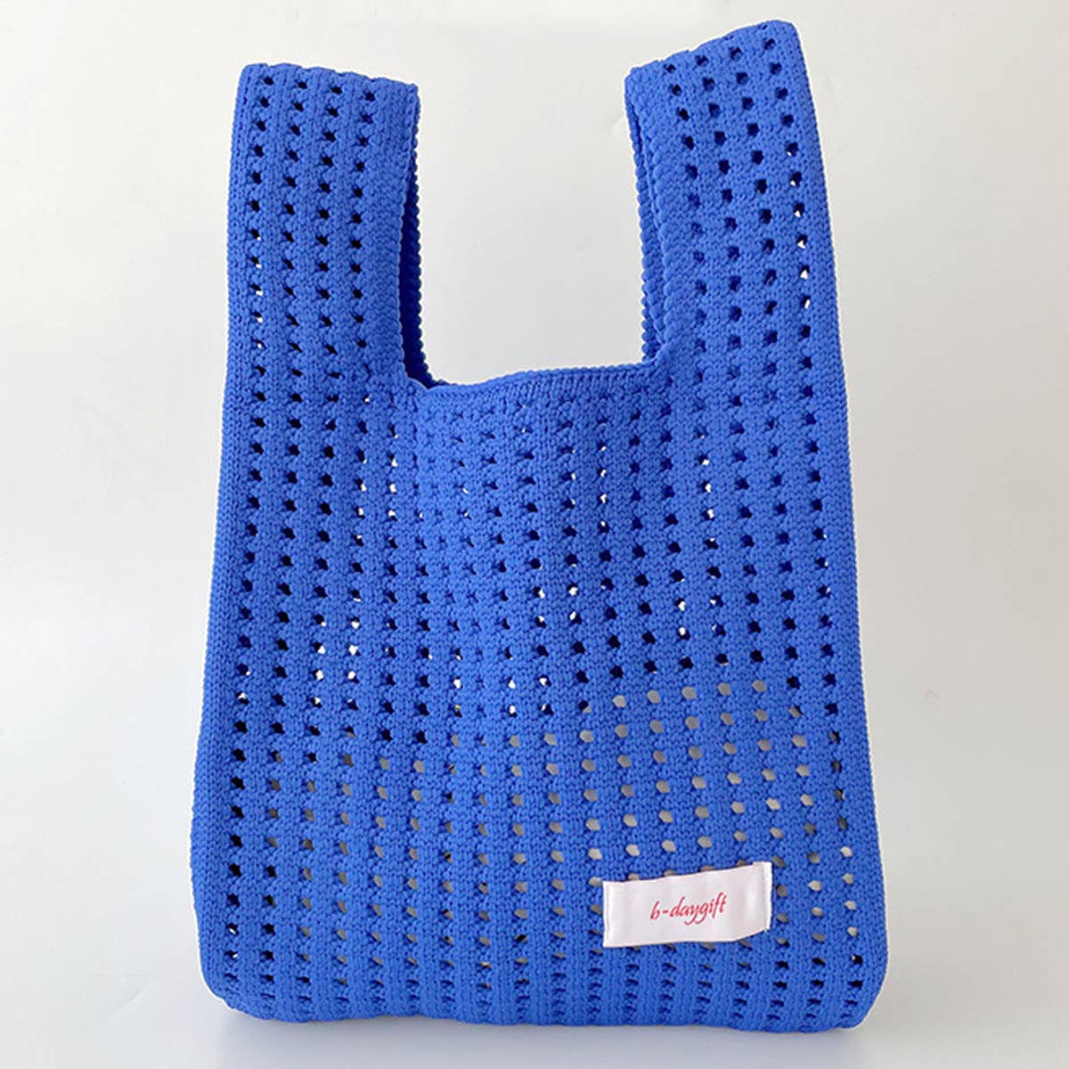 Give your daily style a playful pop with this bright blue knit shoulder bag. Its open, airy weave keeps things lightweight, while the roomy shape makes it perfect for errands, outings, and everything in between. Soft, flexible, and easy to style, it adds a fun hit of texture to any look.