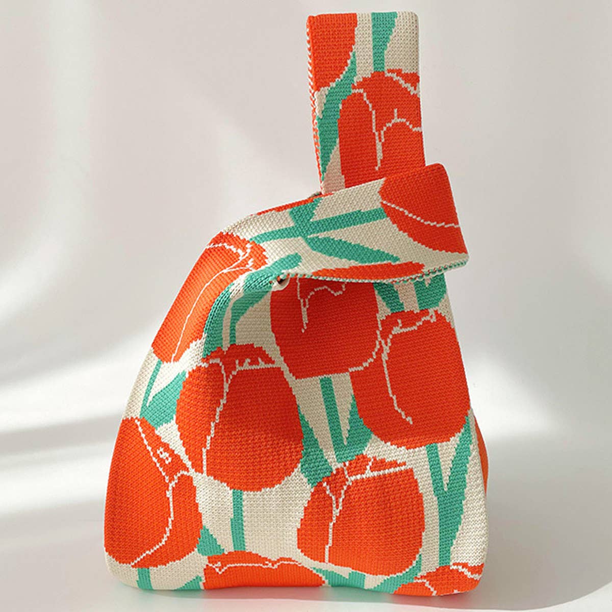 Add a burst of color to your outfit with this orange floral knit shoulder bag. Soft and lightweight, it’s perfect for carrying your essentials while showing off a playful, floral-inspired design. The roomy, flexible shape makes it a charming accessory for casual outings or everyday use.