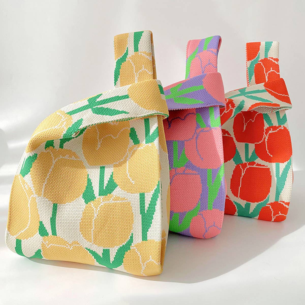 Add a burst of color to your outfit with this orange floral knit shoulder bag. Soft and lightweight, it’s perfect for carrying your essentials while showing off a playful, floral-inspired design. The roomy, flexible shape makes it a charming accessory for casual outings or everyday use.