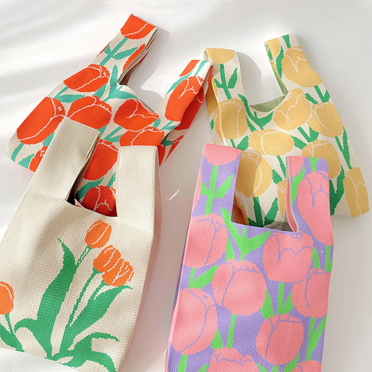 Add a burst of color to your outfit with this orange floral knit shoulder bag. Soft and lightweight, it’s perfect for carrying your essentials while showing off a playful, floral-inspired design. The roomy, flexible shape makes it a charming accessory for casual outings or everyday use.