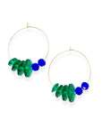 Designed with sculptural flow and oceanic calm, the Large Anchor Hoops feature descending teal floral crystals that create a cascading shape. Finished with two rich cobalt stones for balance, these hoops embody a quiet strength and grounded beauty that stands out without shouting.