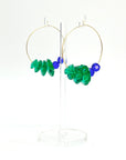 Designed with sculptural flow and oceanic calm, the Large Anchor Hoops feature descending teal floral crystals that create a cascading shape. Finished with two rich cobalt stones for balance, these hoops embody a quiet strength and grounded beauty that stands out without shouting.