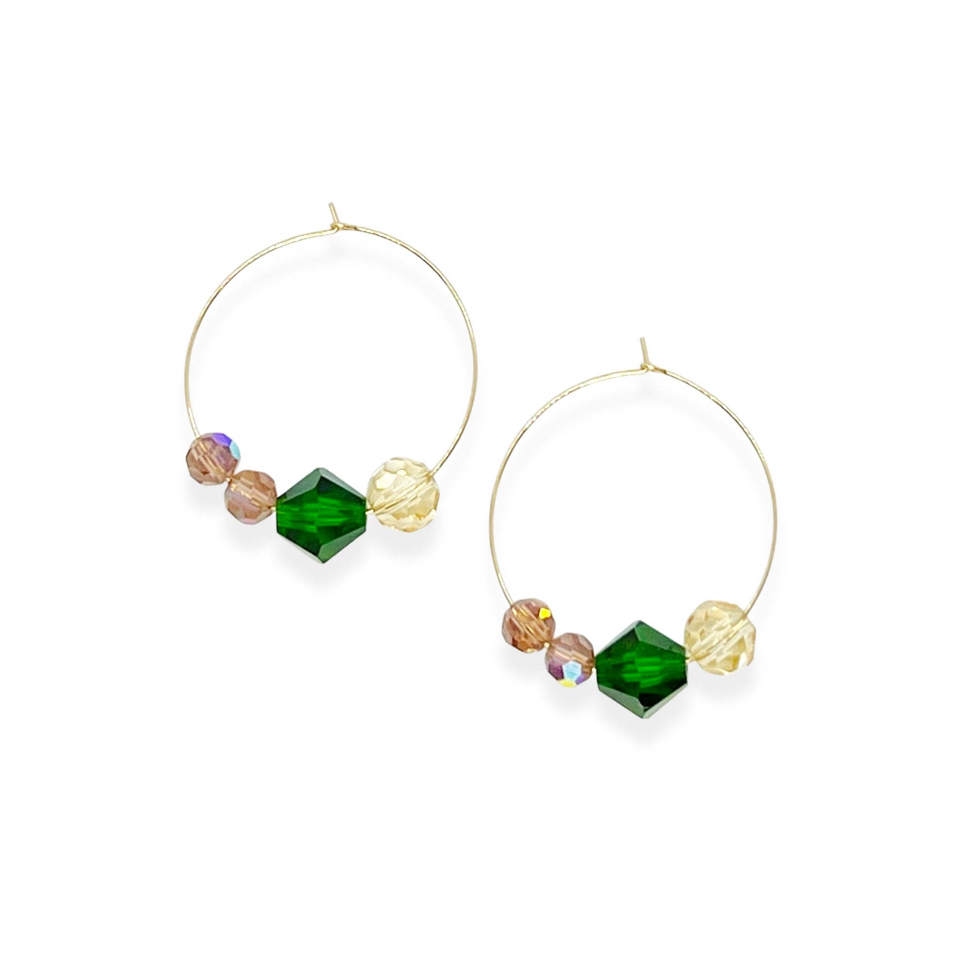Elegant with a hint of drama, the Large Muse Hoops are a wearable palette of champagne, amethyst, and emerald crystals. Their rich, layered tones and refined silhouette make them a perfect pairing for elevated moments—or everyday beauty with a little mystique.