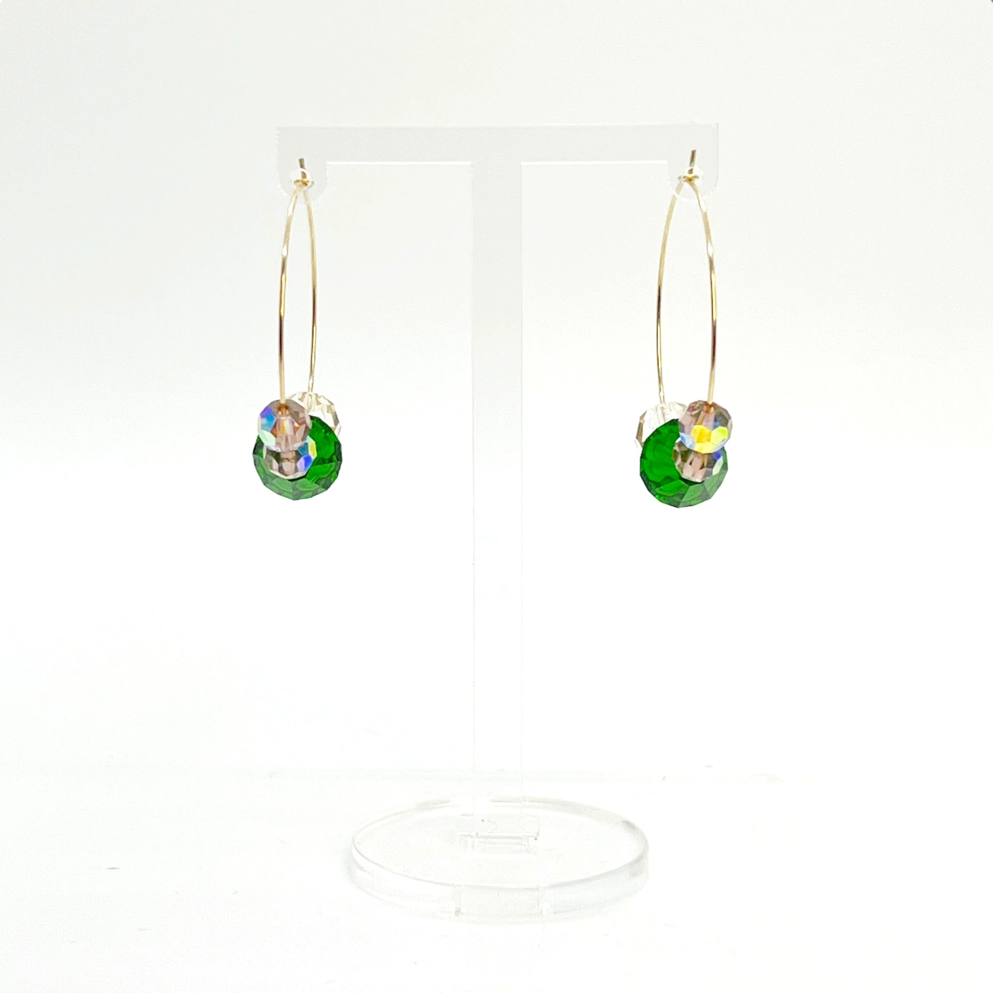 Elegant with a hint of drama, the Large Muse Hoops are a wearable palette of champagne, amethyst, and emerald crystals. Their rich, layered tones and refined silhouette make them a perfect pairing for elevated moments—or everyday beauty with a little mystique.