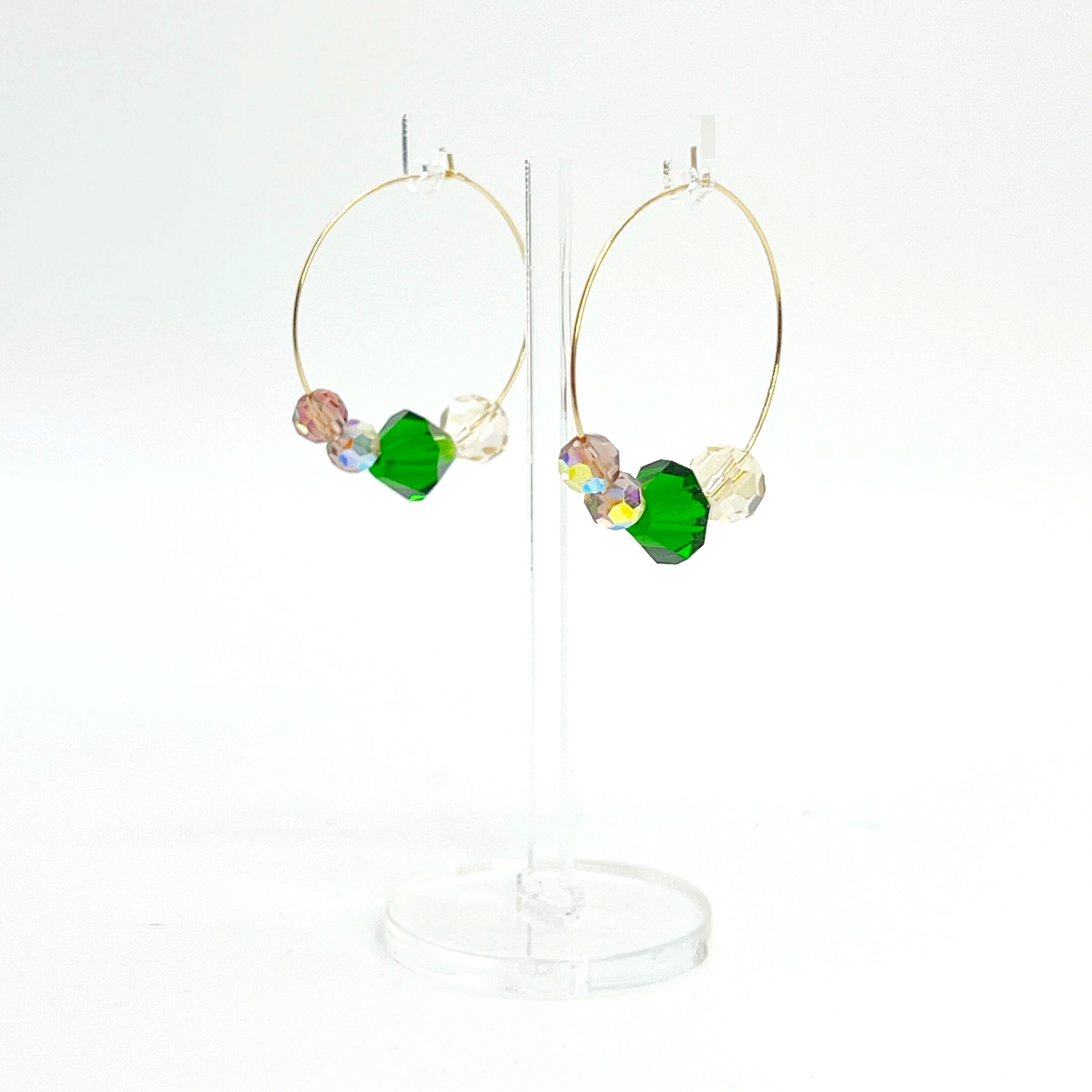 Elegant with a hint of drama, the Large Muse Hoops are a wearable palette of champagne, amethyst, and emerald crystals. Their rich, layered tones and refined silhouette make them a perfect pairing for elevated moments—or everyday beauty with a little mystique.