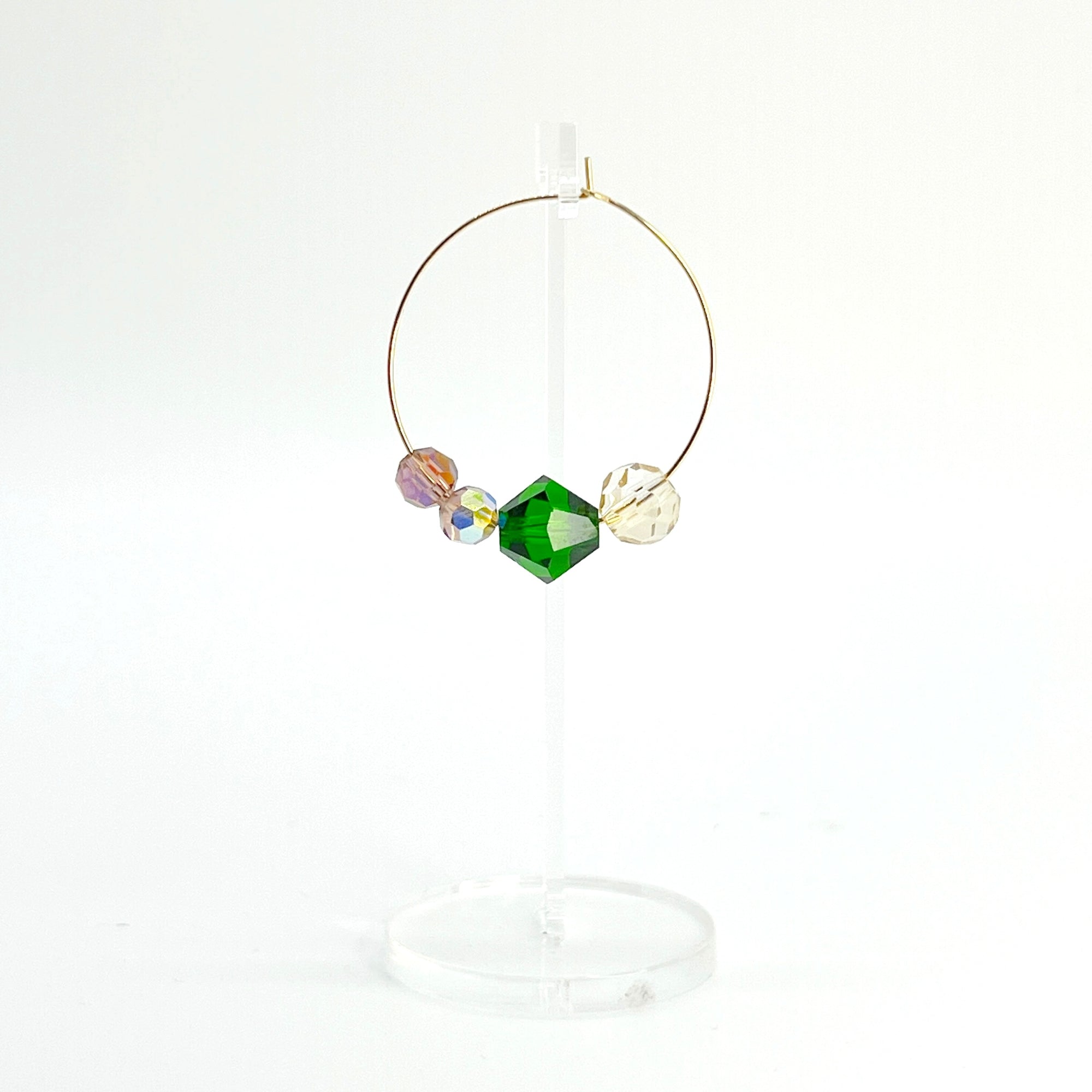 Elegant with a hint of drama, the Large Muse Hoops are a wearable palette of champagne, amethyst, and emerald crystals. Their rich, layered tones and refined silhouette make them a perfect pairing for elevated moments—or everyday beauty with a little mystique.