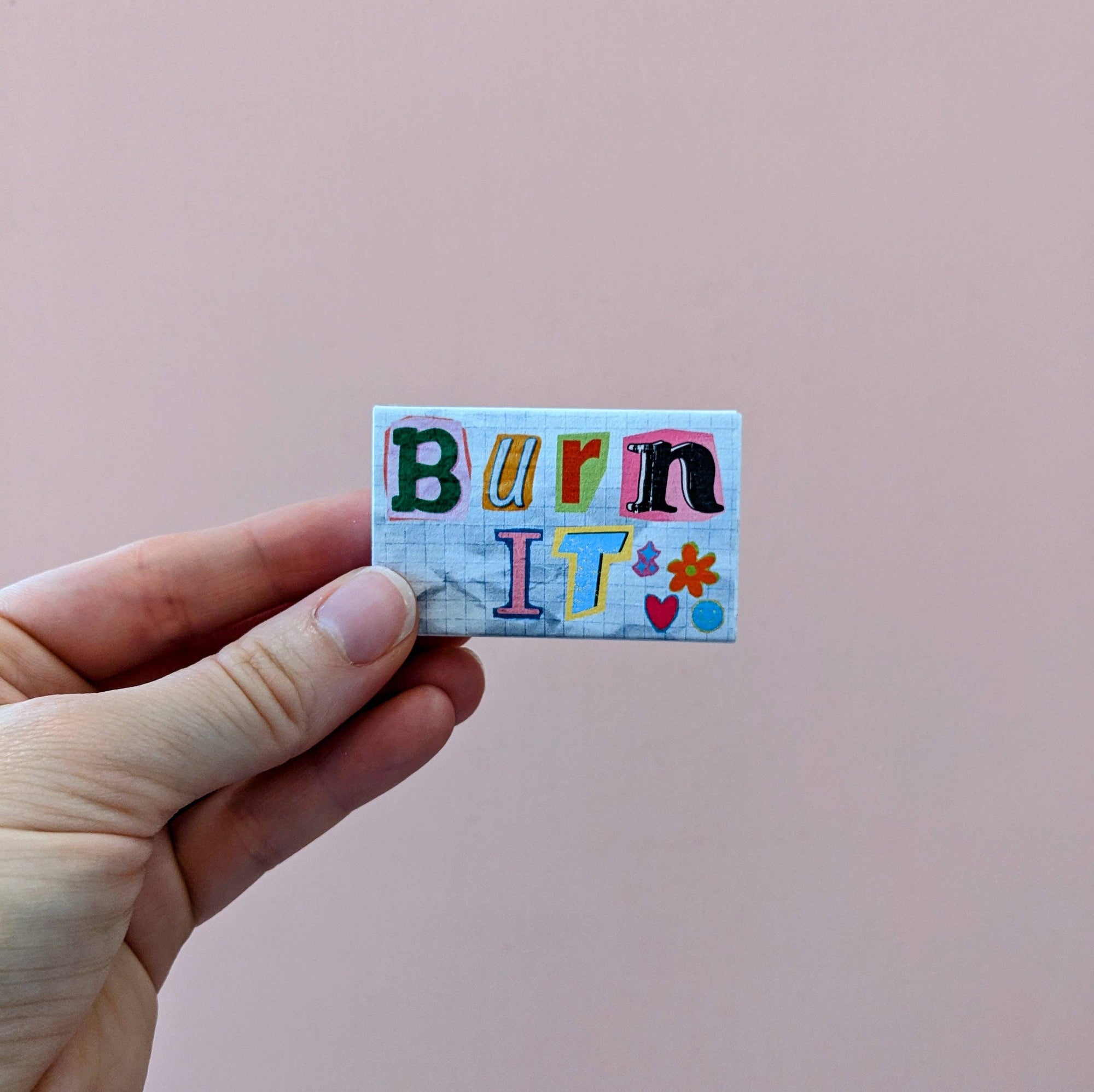 For when “let it go” just doesn’t cut it: BURN IT. This matchbox is your tiny, colorful hype squad for setting fire (literally or metaphorically) to whatever’s holding you back. Old love letters? Burn ‘em. Bad vibes? Torch ‘em. That candle you panic-bought during your “self-care” era? Light it up, baby. With a rebellious cut-and-paste design and zero patience for nonsense, this matchbox says what you’re thinking: some things are better in flames.