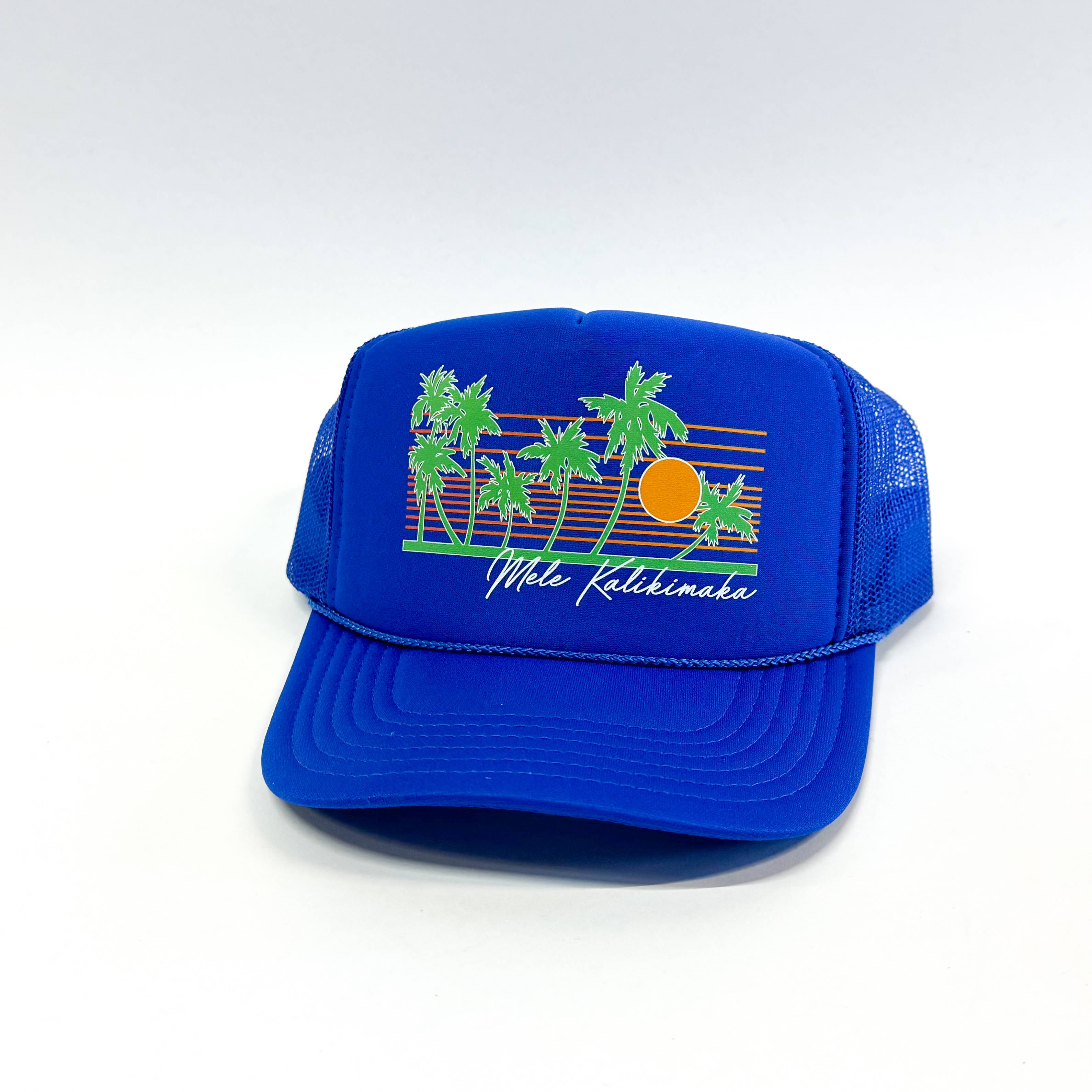 Blue trucker hat with palm tree and sun design on a white background