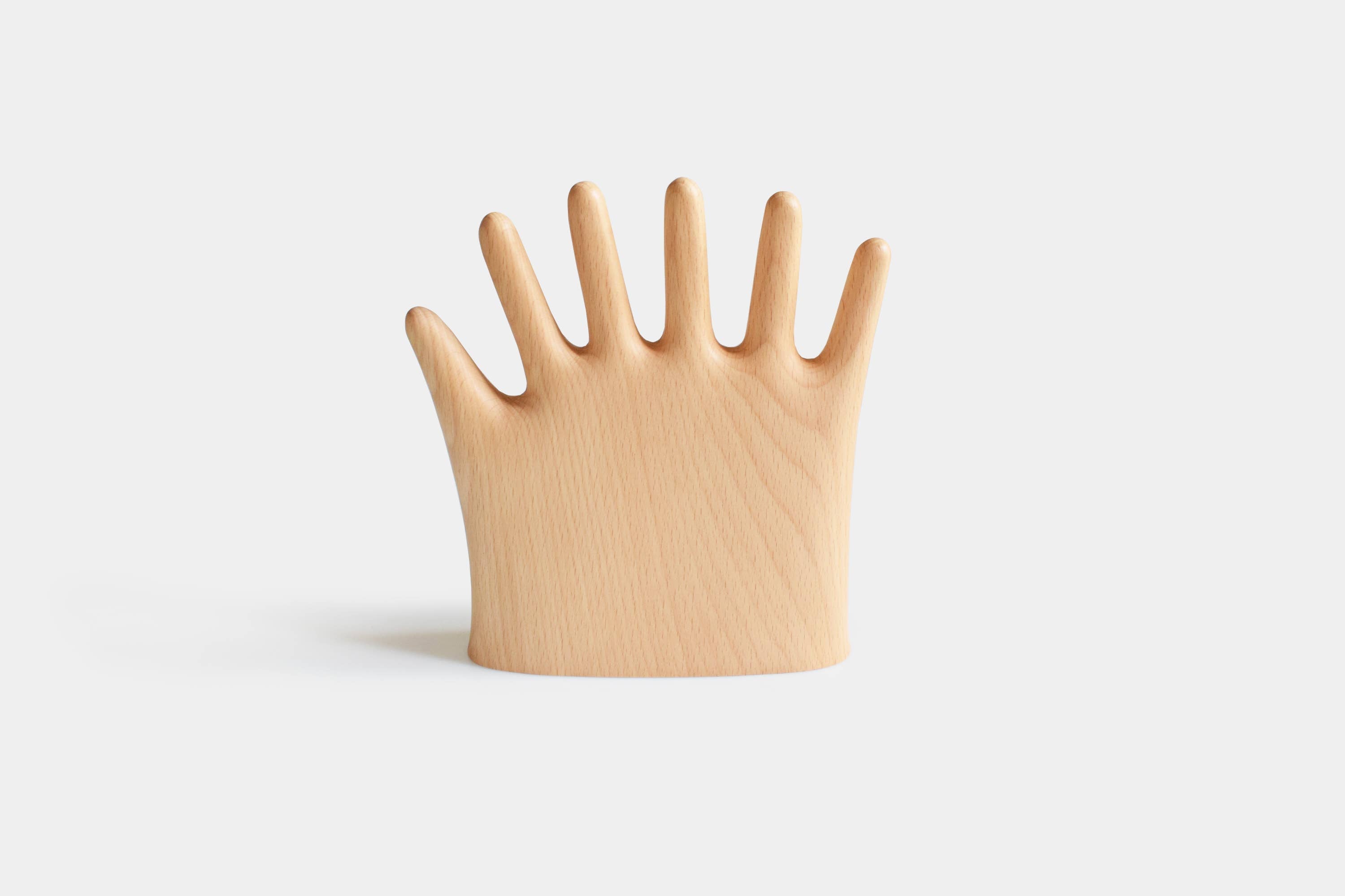 Keep your rings, necklaces, and bracelets organized with a fun twist. This beech wood jewelry display features a regular hand with one extra finger, giving you six spots to hang all your favorite pieces. Perfect for adding a whimsical and functional accent to your dresser or vanity.