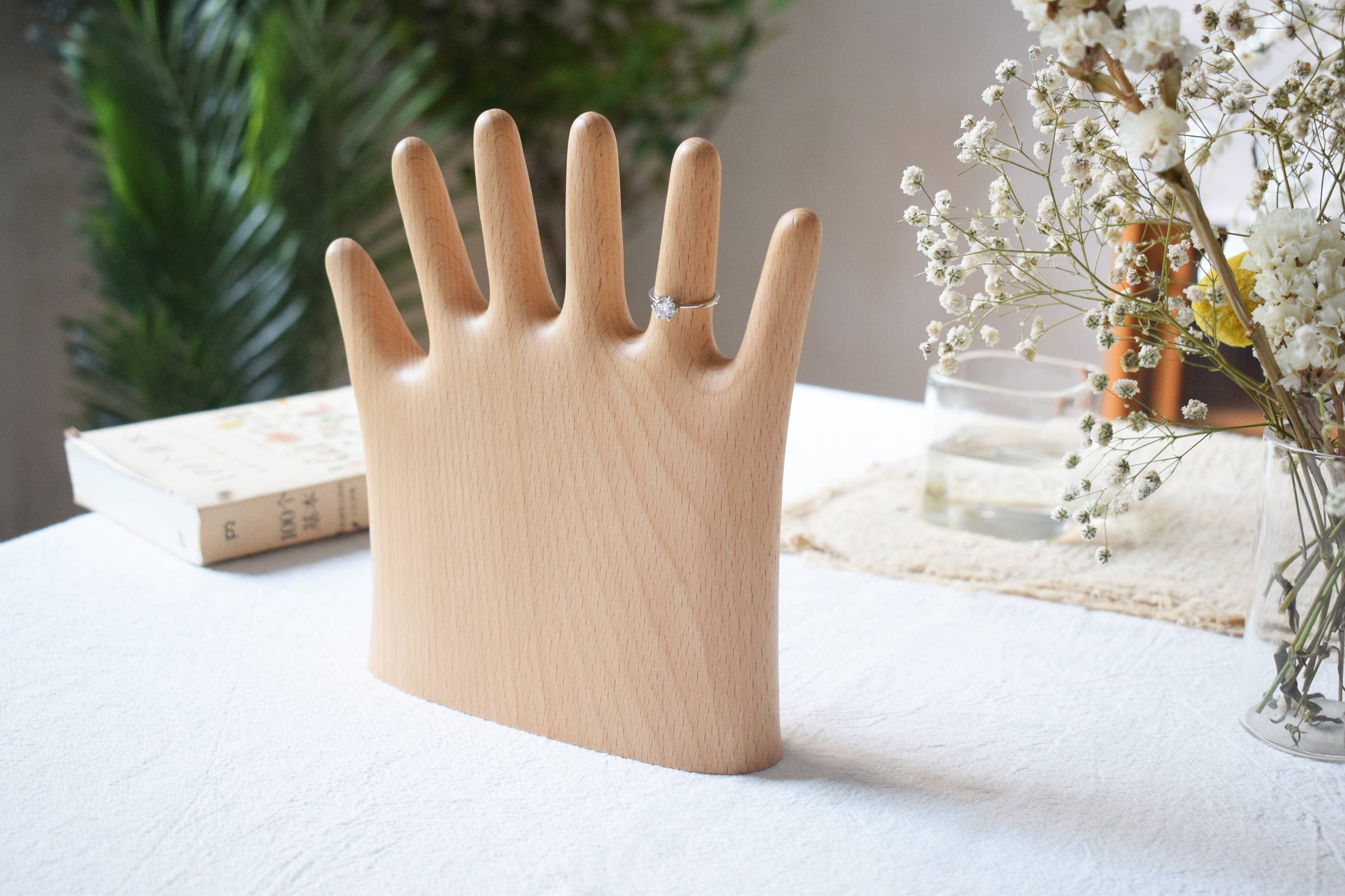 Keep your rings, necklaces, and bracelets organized with a fun twist. This beech wood jewelry display features a regular hand with one extra finger, giving you six spots to hang all your favorite pieces. Perfect for adding a whimsical and functional accent to your dresser or vanity.