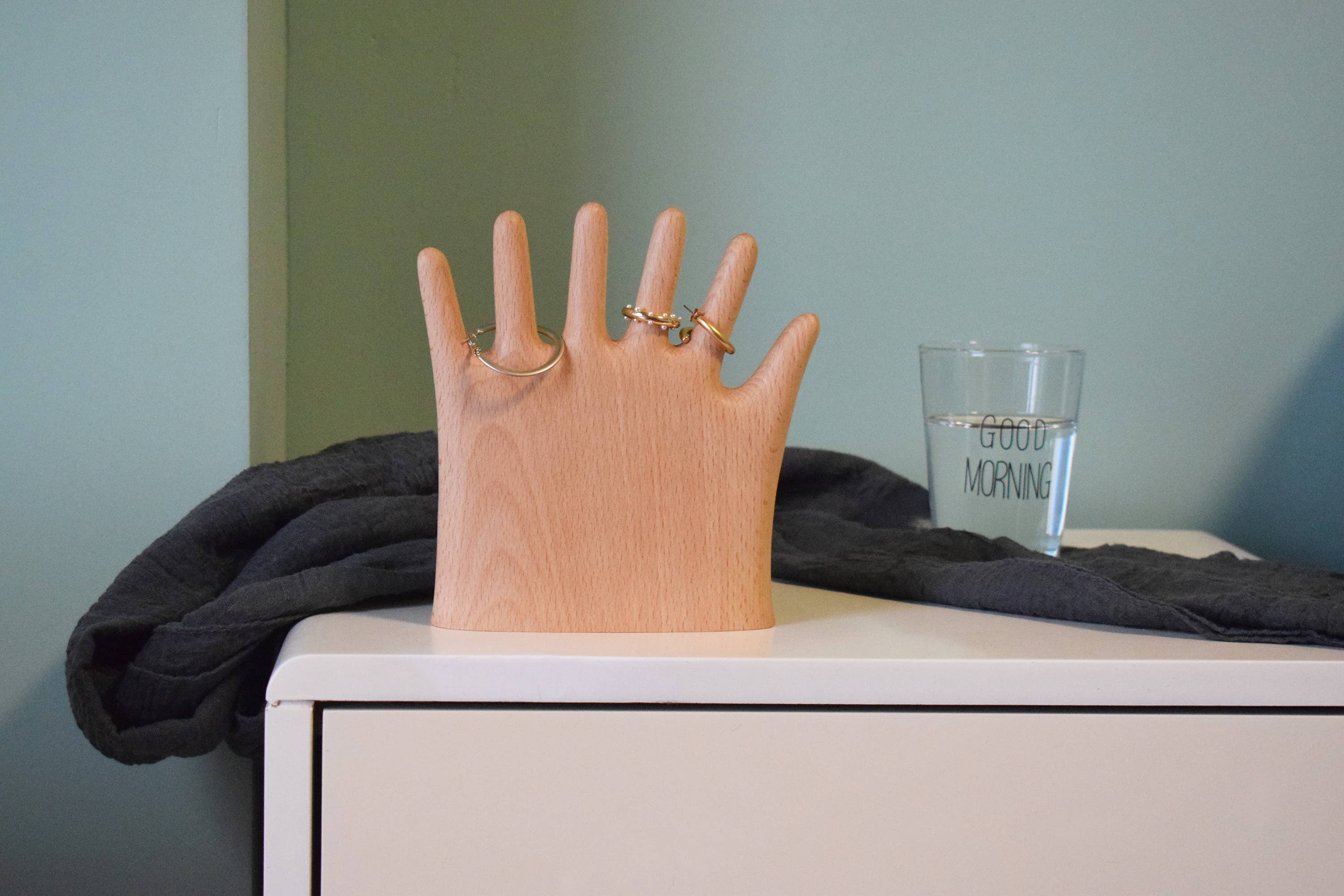 Keep your rings, necklaces, and bracelets organized with a fun twist. This beech wood jewelry display features a regular hand with one extra finger, giving you six spots to hang all your favorite pieces. Perfect for adding a whimsical and functional accent to your dresser or vanity.