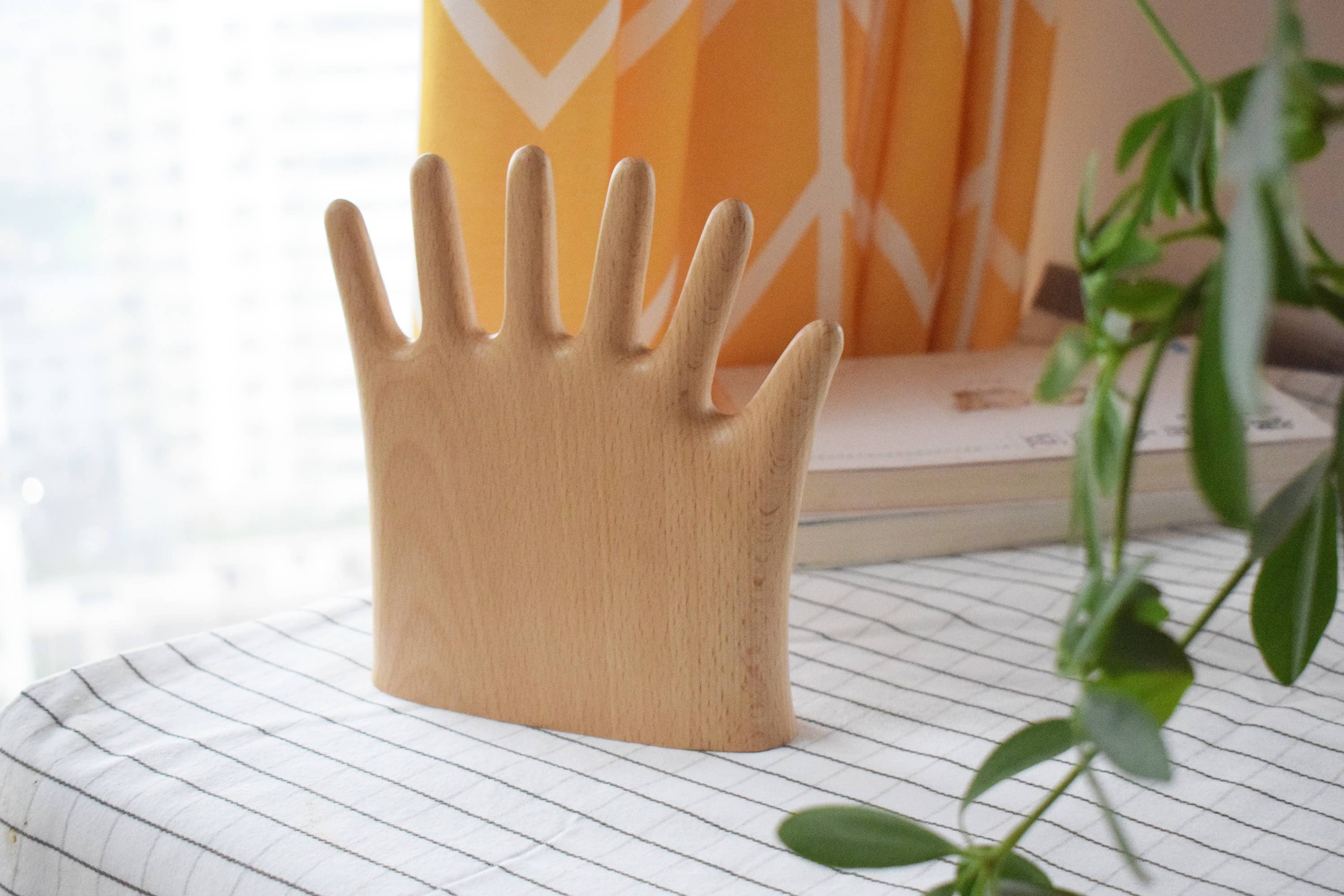 Keep your rings, necklaces, and bracelets organized with a fun twist. This beech wood jewelry display features a regular hand with one extra finger, giving you six spots to hang all your favorite pieces. Perfect for adding a whimsical and functional accent to your dresser or vanity.