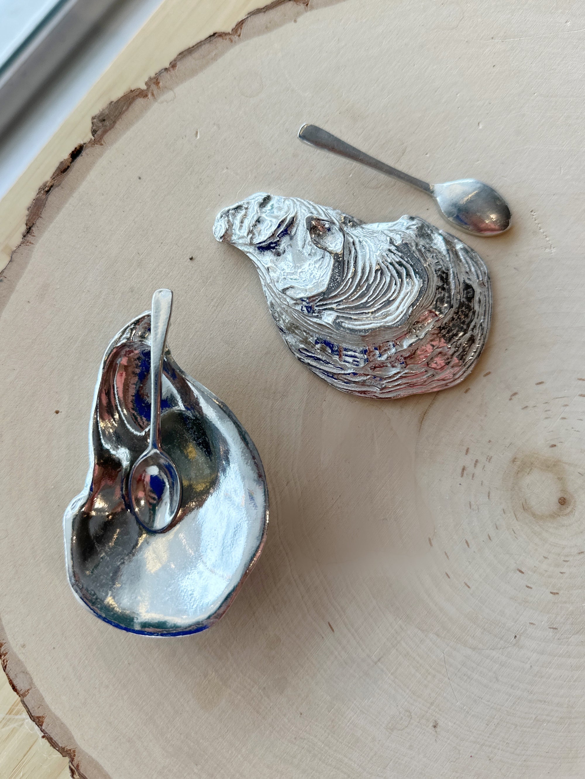 This salt cellar, shaped like an oyster shell, will add a dash of style and whimsy to your table. Includes a miniature spoon for perfectly sprinkling spices. You'll want to keep this salt cellar out on your table full-time. The days of salt being banished to the spice cabinet is behind you! Fine hand-crafted pewter, made in Canada.