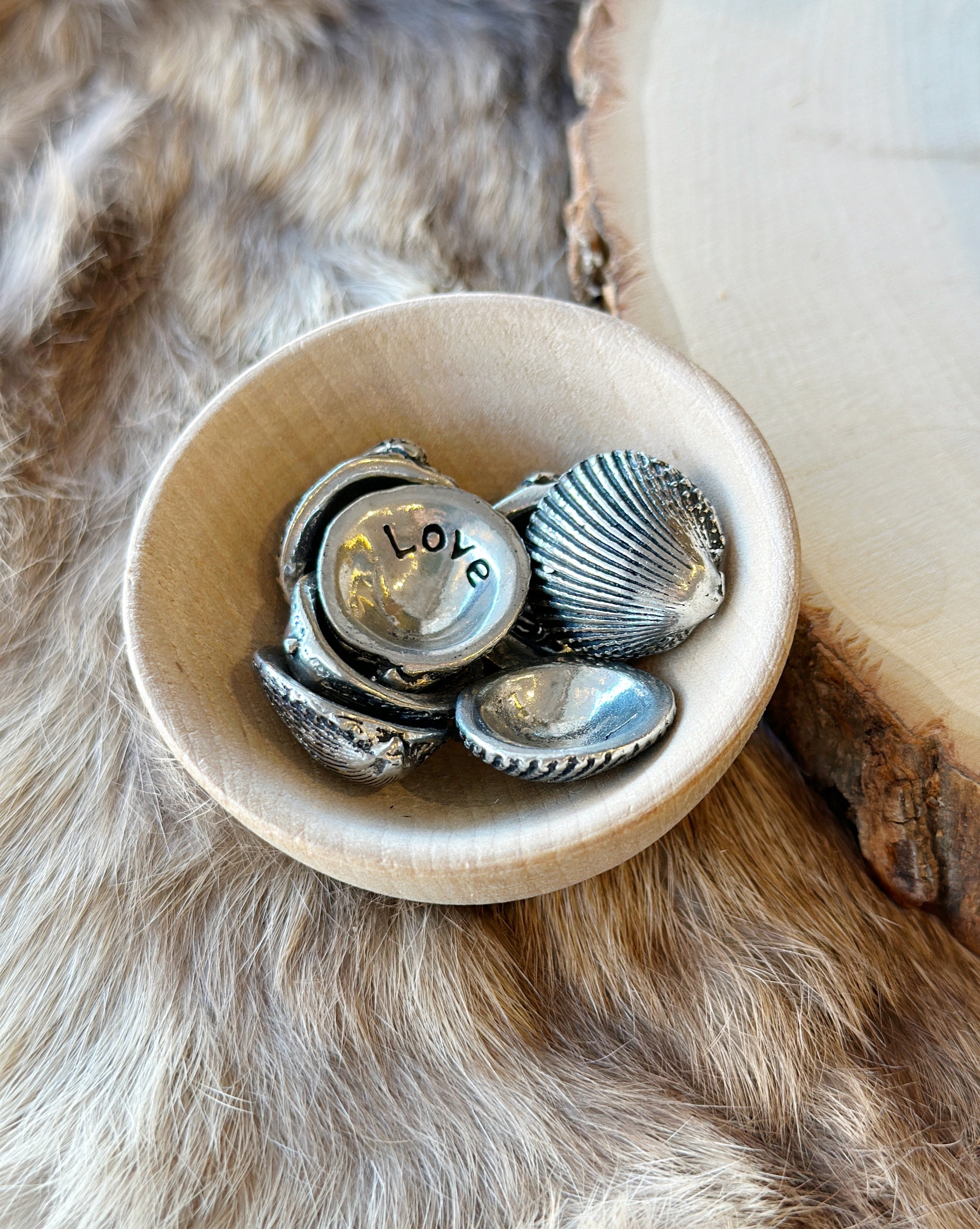 A meaningful keepsake, this pewter shell reveals "love" on the back. Great for collections, gifts, or sharing positivity. Handmade in Canada.