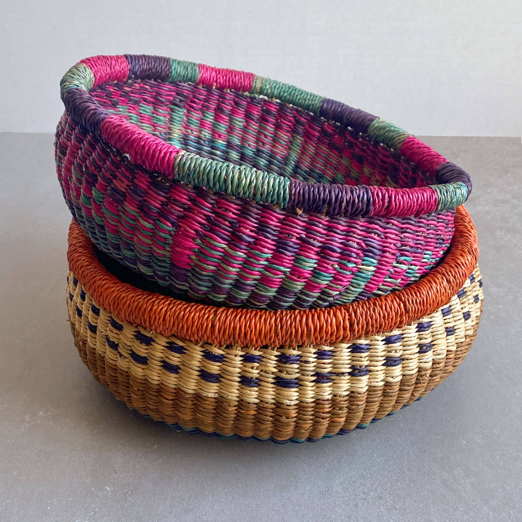 Decorate your home with a Round Bolga Basket, handwoven by experienced women in Ghana's Bolgatanga region using locally sourced veta vera grass. Each basket is woven wet and can be re-shaped by adding water. Durable and washable, these baskets are a beautiful and unique addition to your decor. Fun fact: kinkahe is a local name for veta vera grass in Ghana!