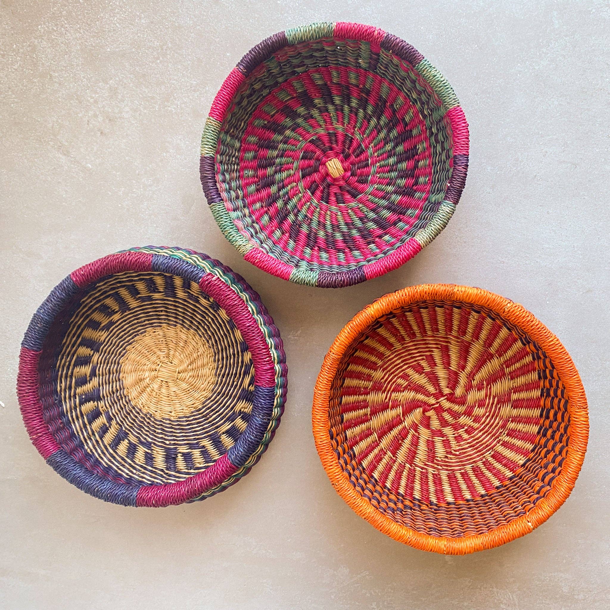 Decorate your home with a Round Bolga Basket, handwoven by experienced women in Ghana's Bolgatanga region using locally sourced veta vera grass. Each basket is woven wet and can be re-shaped by adding water. Durable and washable, these baskets are a beautiful and unique addition to your decor. Fun fact: kinkahe is a local name for veta vera grass in Ghana!