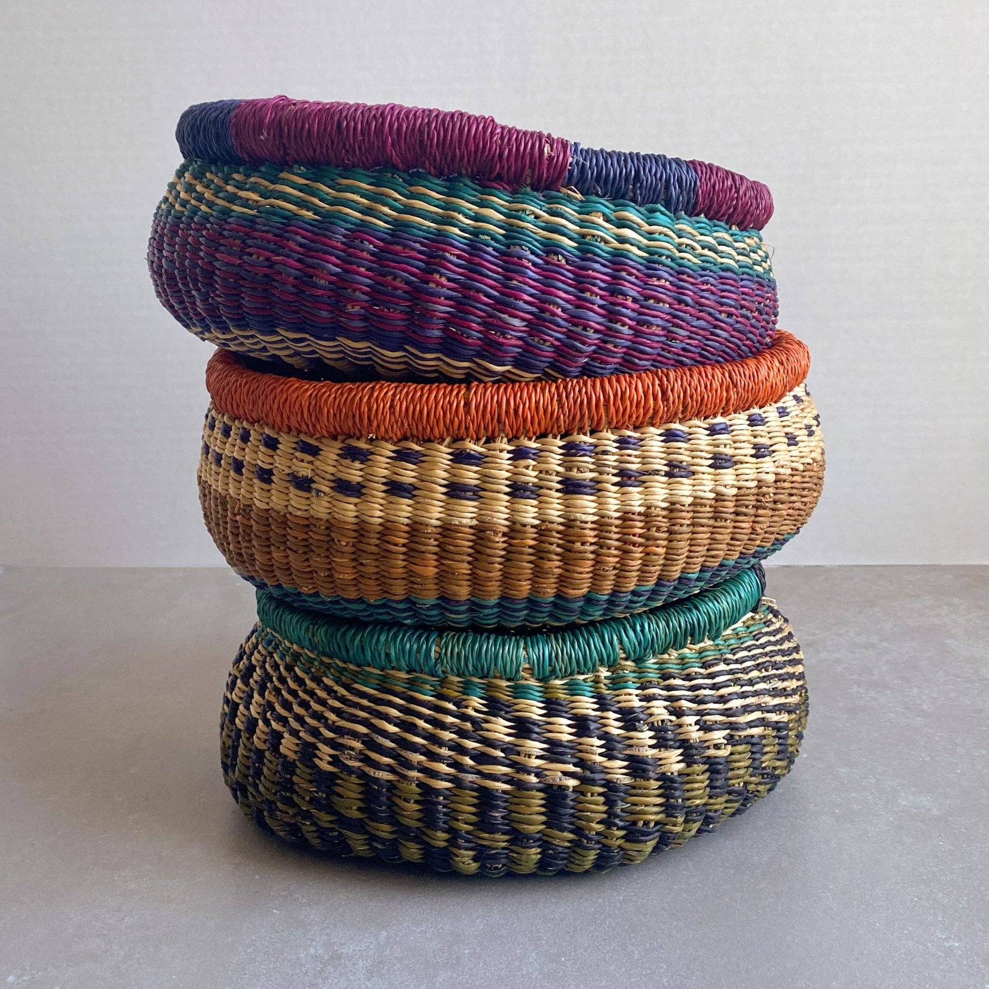 Decorate your home with a Round Bolga Basket, handwoven by experienced women in Ghana's Bolgatanga region using locally sourced veta vera grass. Each basket is woven wet and can be re-shaped by adding water. Durable and washable, these baskets are a beautiful and unique addition to your decor. Fun fact: kinkahe is a local name for veta vera grass in Ghana!