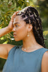 Woman with braids, hand on her head, wearing Taos drop earrings