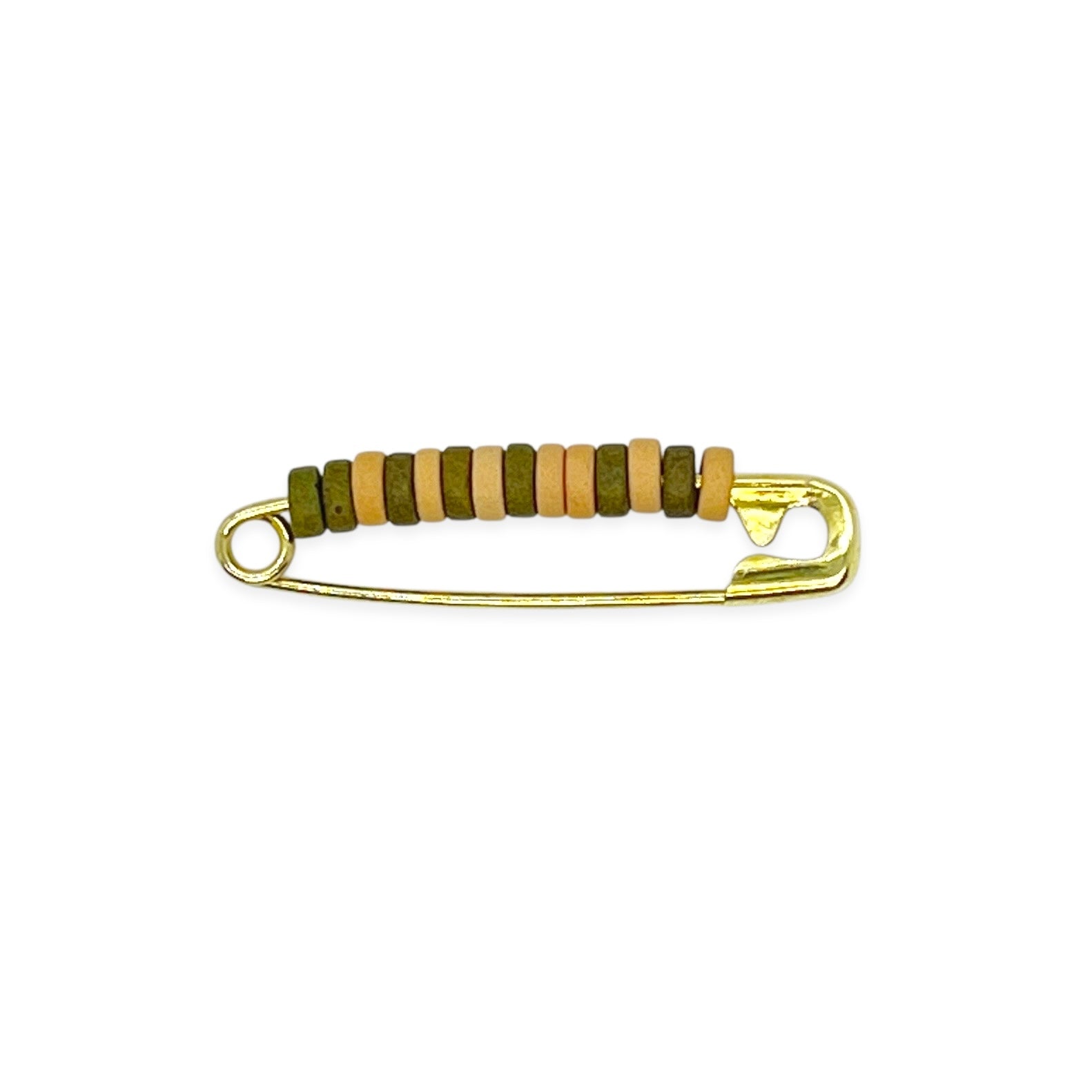 Inspired by the iconic pins from childhood brownie and scout days, our beaded safety pin shoe pin blends solid brass durability with colorful Greek ceramic beads for a fresh take on a classic. Each pin is crafted to add a playful, nostalgic touch to your favorite shoes, bags, or gear — a small symbol of friendship and adventure.