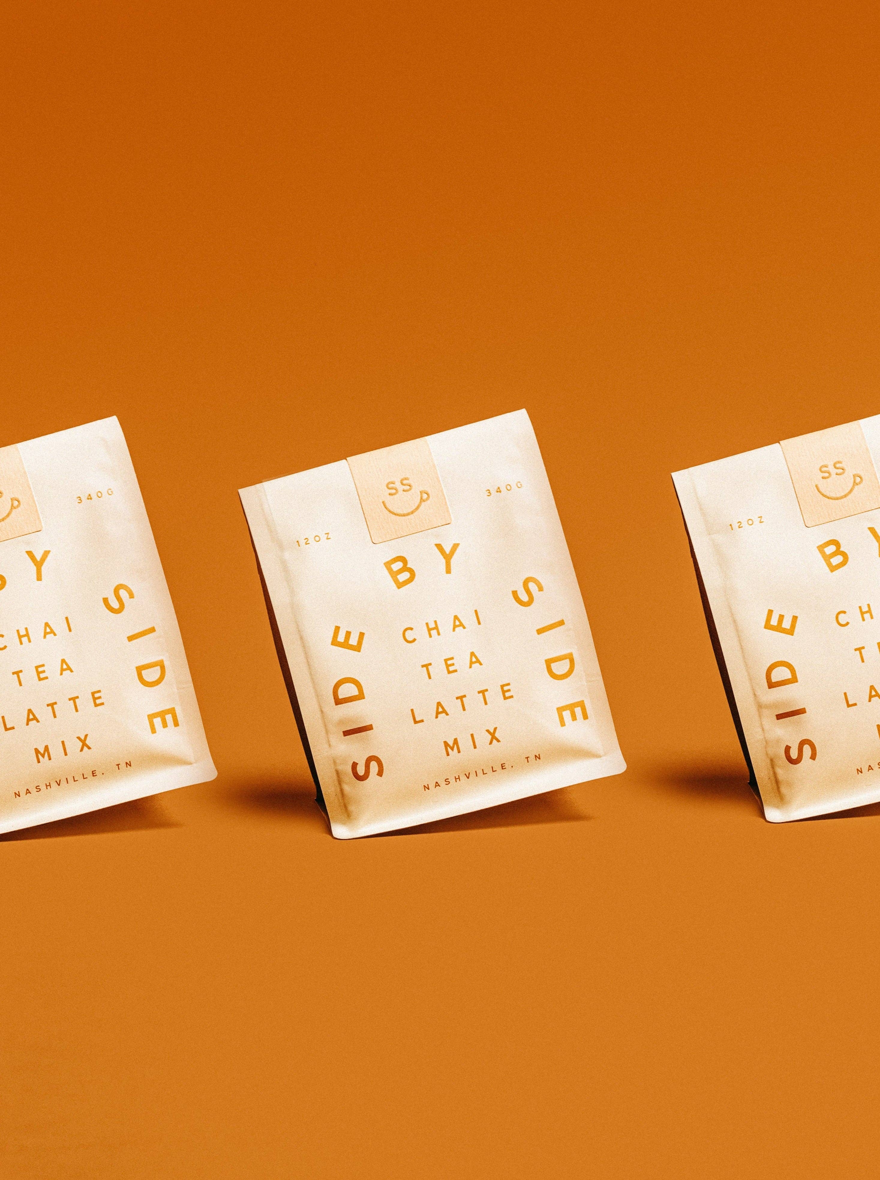 Three packages of Side by Side Chai Tea Latte Mix on an orange background