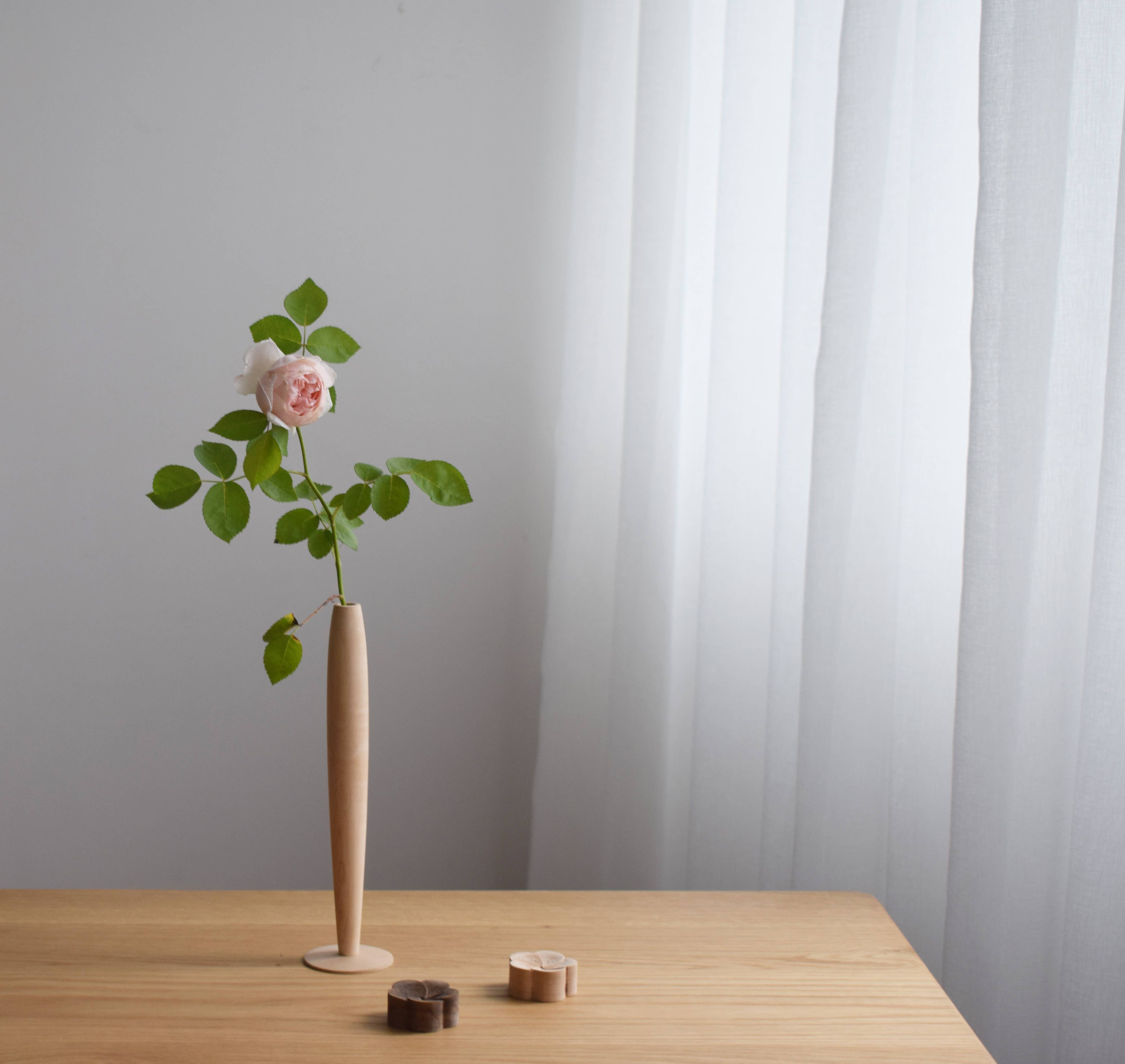 Crafted from fine maple wood and delicately polished, this single flower vase embodies the elegance of Eastern Zen aesthetics. Minimal yet refined, it adds a serene touch to any space—perfect for home décor or as a thoughtful housewarming gift.