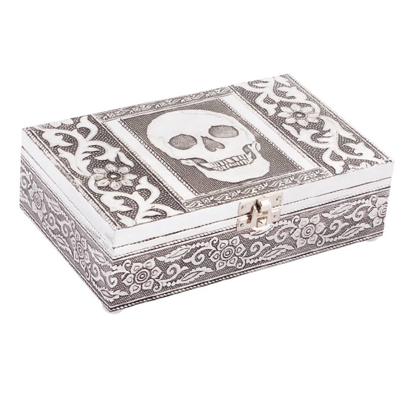 Decorative jewelry box with skull design on a white background