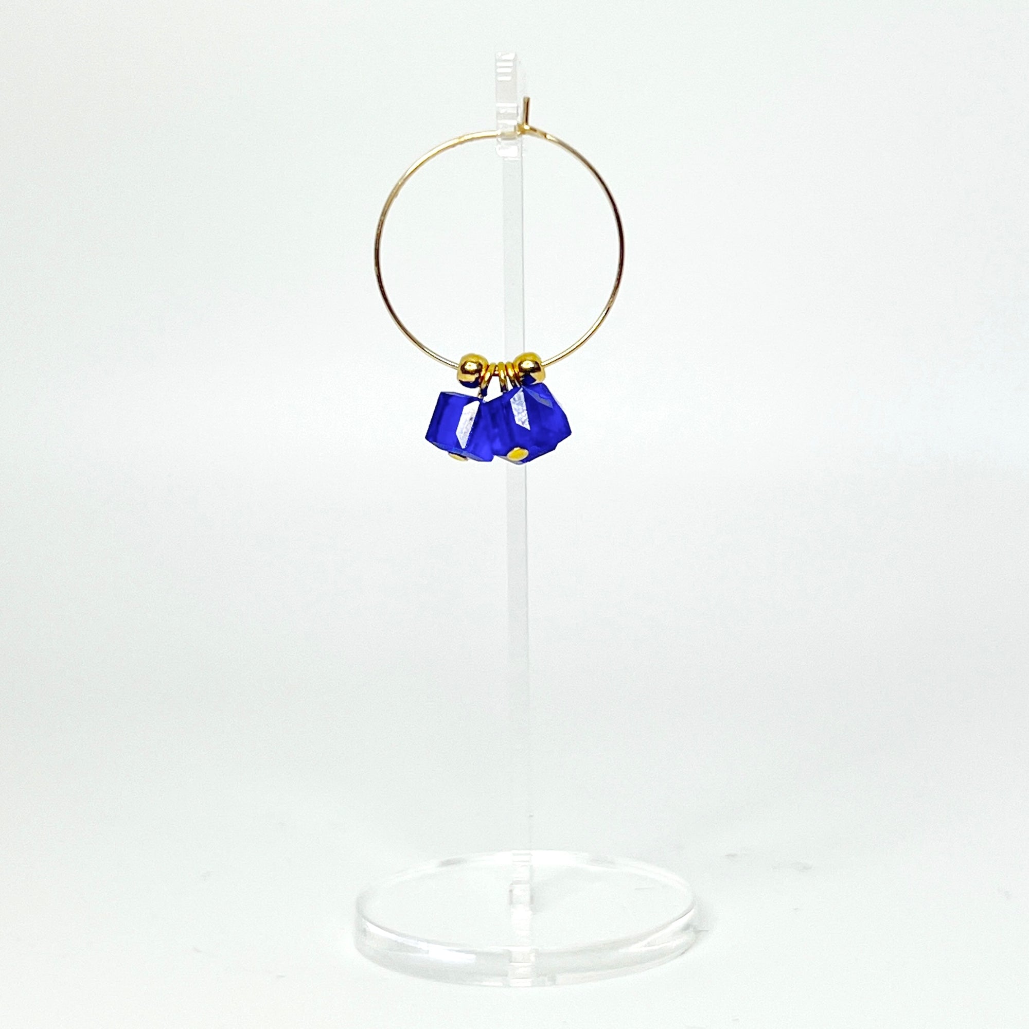 Cool, collected, and effortlessly modern. The Small Anchor Hoops feature a trio of bold cobalt crystal cubes clustered together for a structured, sculptural silhouette. Subtle but striking, they’re your go-to hoops when you want a pop of color with clean, confident lines.