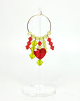 Joyful, flirty, and full of energy—these Small Spark Hoops are a burst of personality. A radiant heart-shaped crystal takes center stage, framed by watermelon and chartreuse tones that feel like summer bottled up. A scattering of dangling crystals adds playful movement, making these hoops perfect for anyone who loves to stand out and shine.
