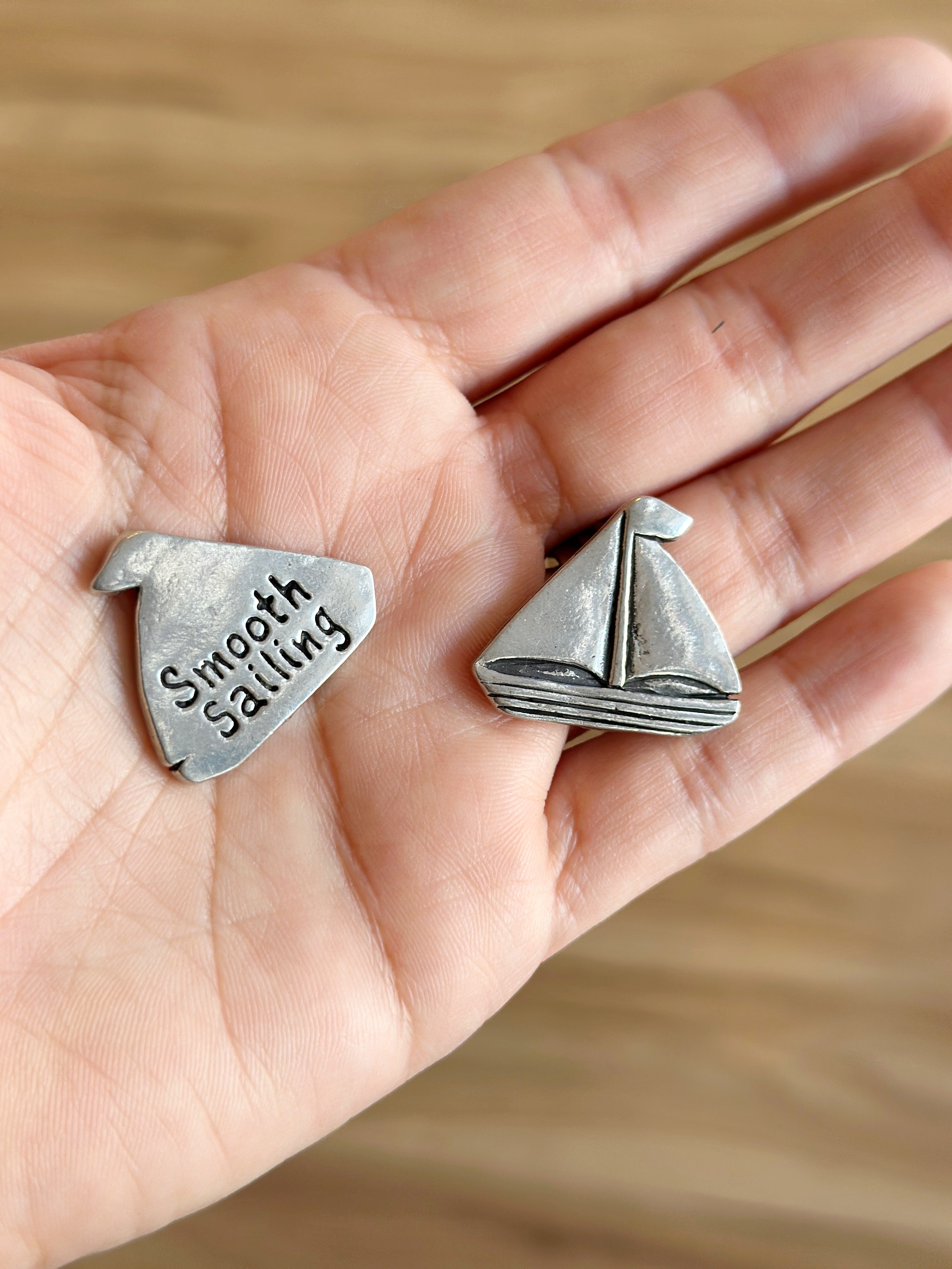 Set sail with the Smooth Sailing Coin! Handcrafted pewter with a sailboat front & “Smooth Sailing” back—perfect for pockets, bags, or a touch of home charm.