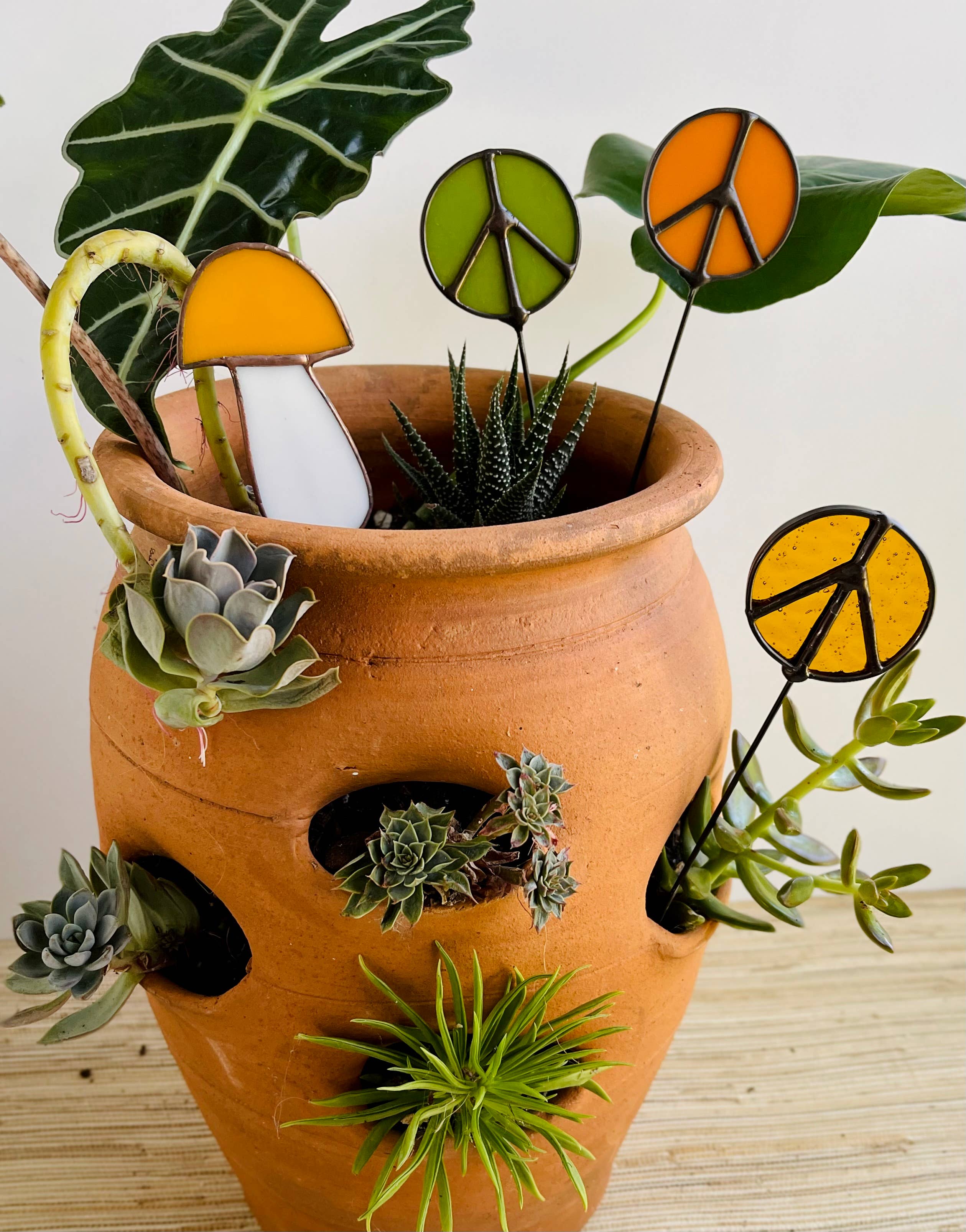 Handcrafted amber stained glass mushroom adds charm to plants or gardens. Weatherproof and pet-safe. Perfect for unique home decor and garden gifts.