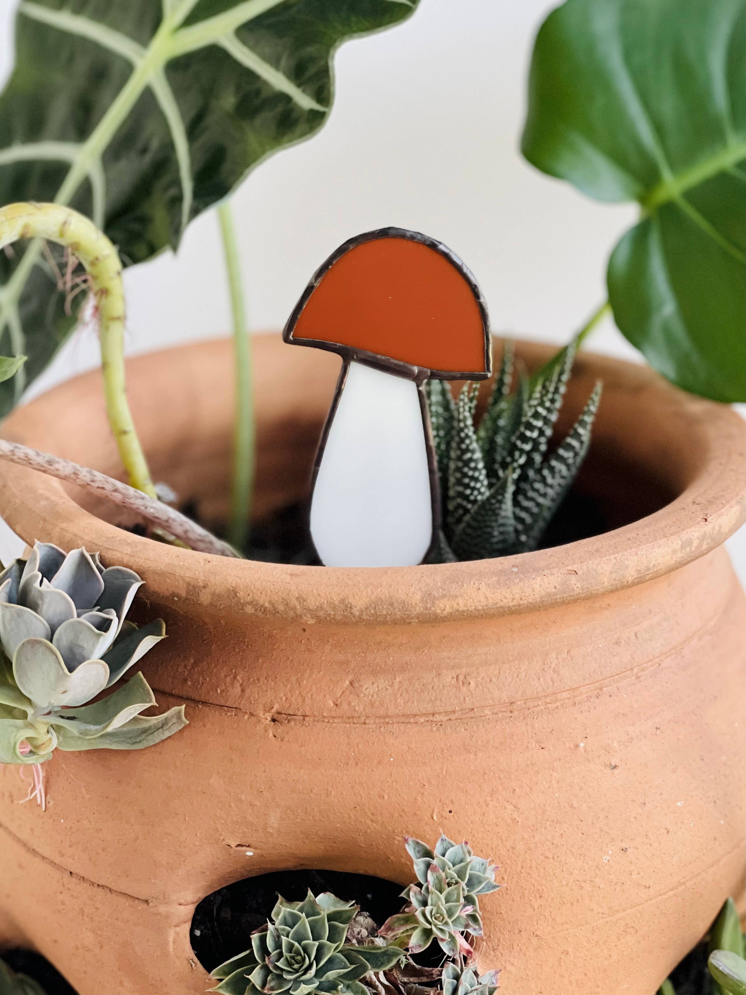 Handcrafted amber stained glass mushroom adds charm to plants or gardens. Weatherproof and pet-safe. Perfect for unique home decor and garden gifts.