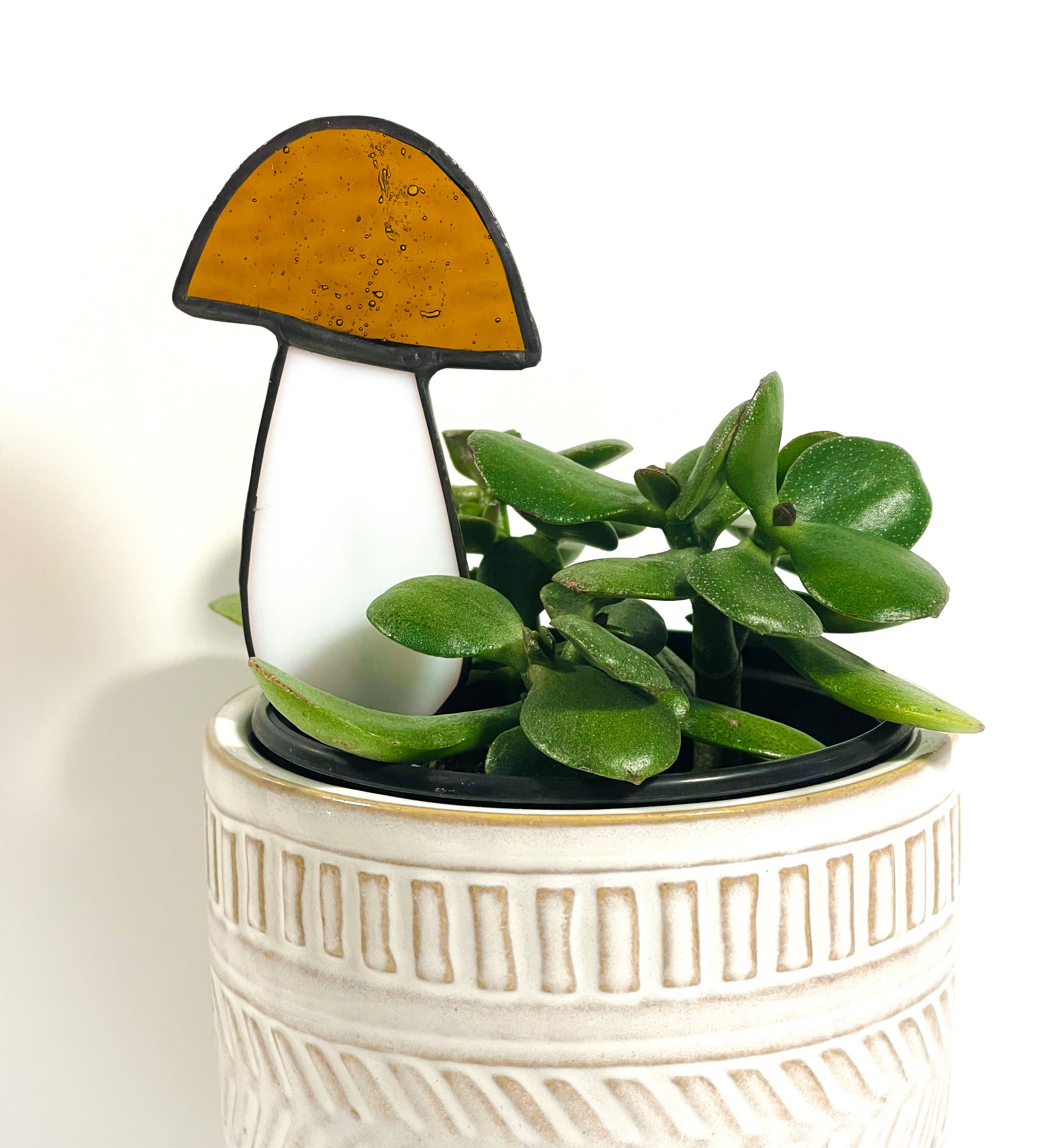 Handcrafted amber stained glass mushroom adds charm to plants or gardens. Weatherproof and pet-safe. Perfect for unique home decor and garden gifts.