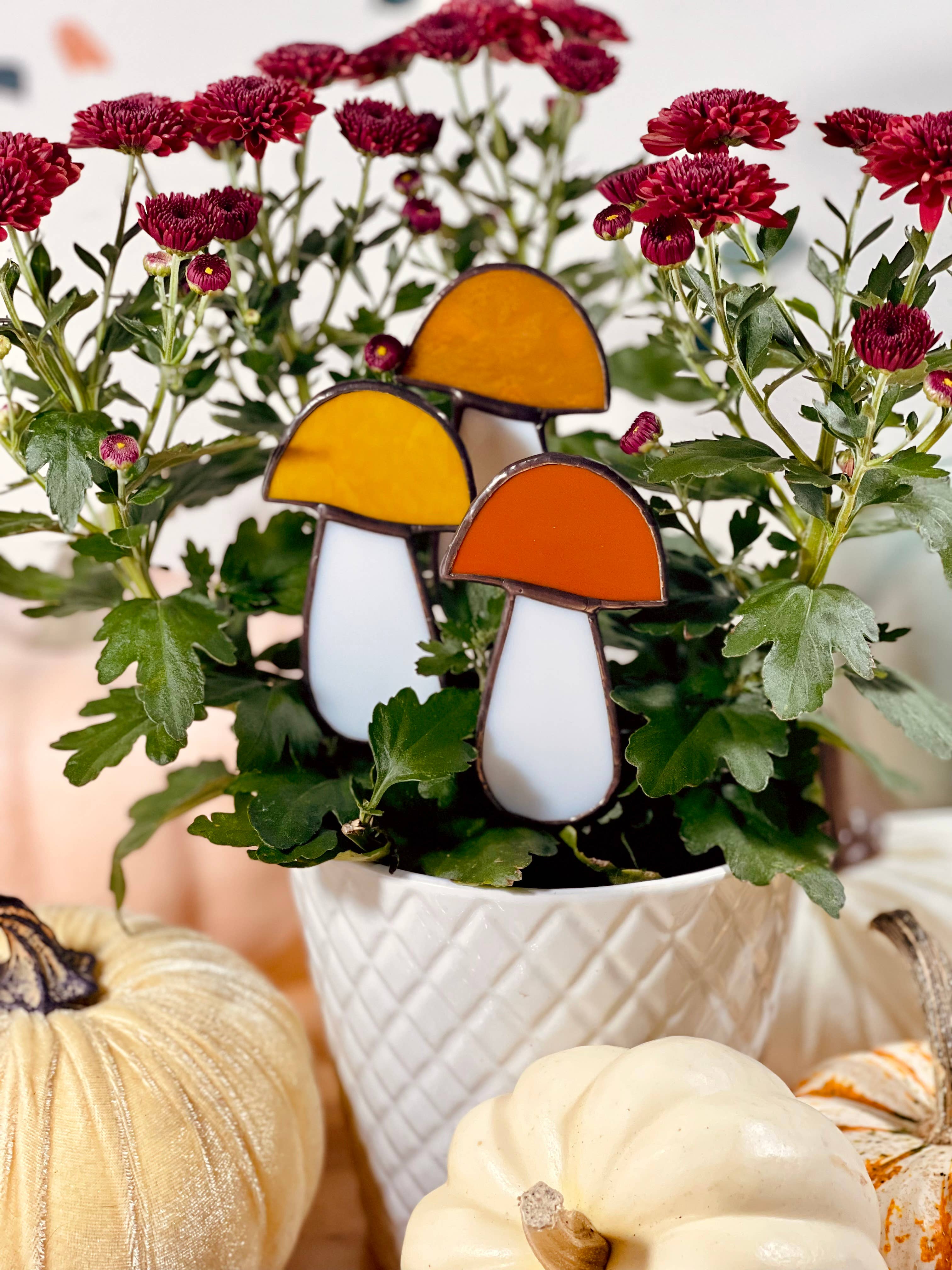 Handcrafted amber stained glass mushroom adds charm to plants or gardens. Weatherproof and pet-safe. Perfect for unique home decor and garden gifts.
