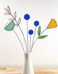 Bring a pop of color and artistry to your home with this handcrafted set of stained glass blue globe thistles by Samara Designs Studio. Each stem is carefully handmade using cobalt blue stained glass, cut and assembled with care to create a lasting botanical accent that will never wilt or fade.