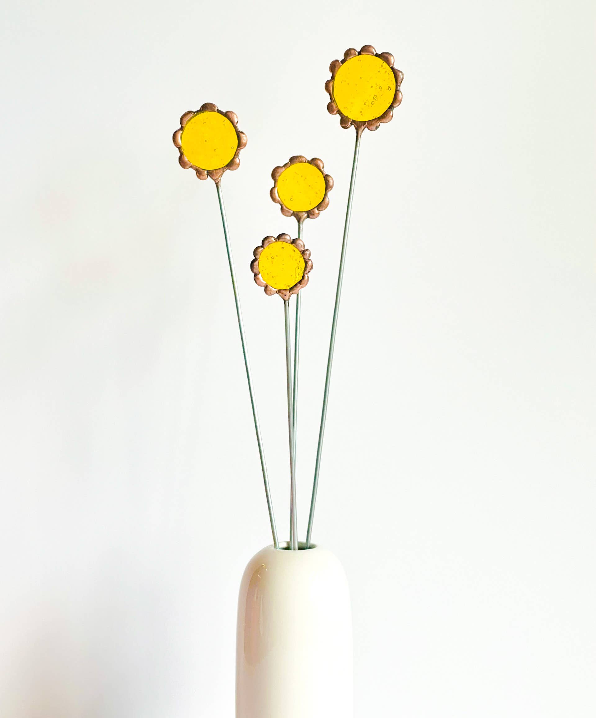 Handmade stained glass buttercups add bright yellow charm to any space. Pet-safe, low-maintenance decor for vases or planters. Set of four stems.