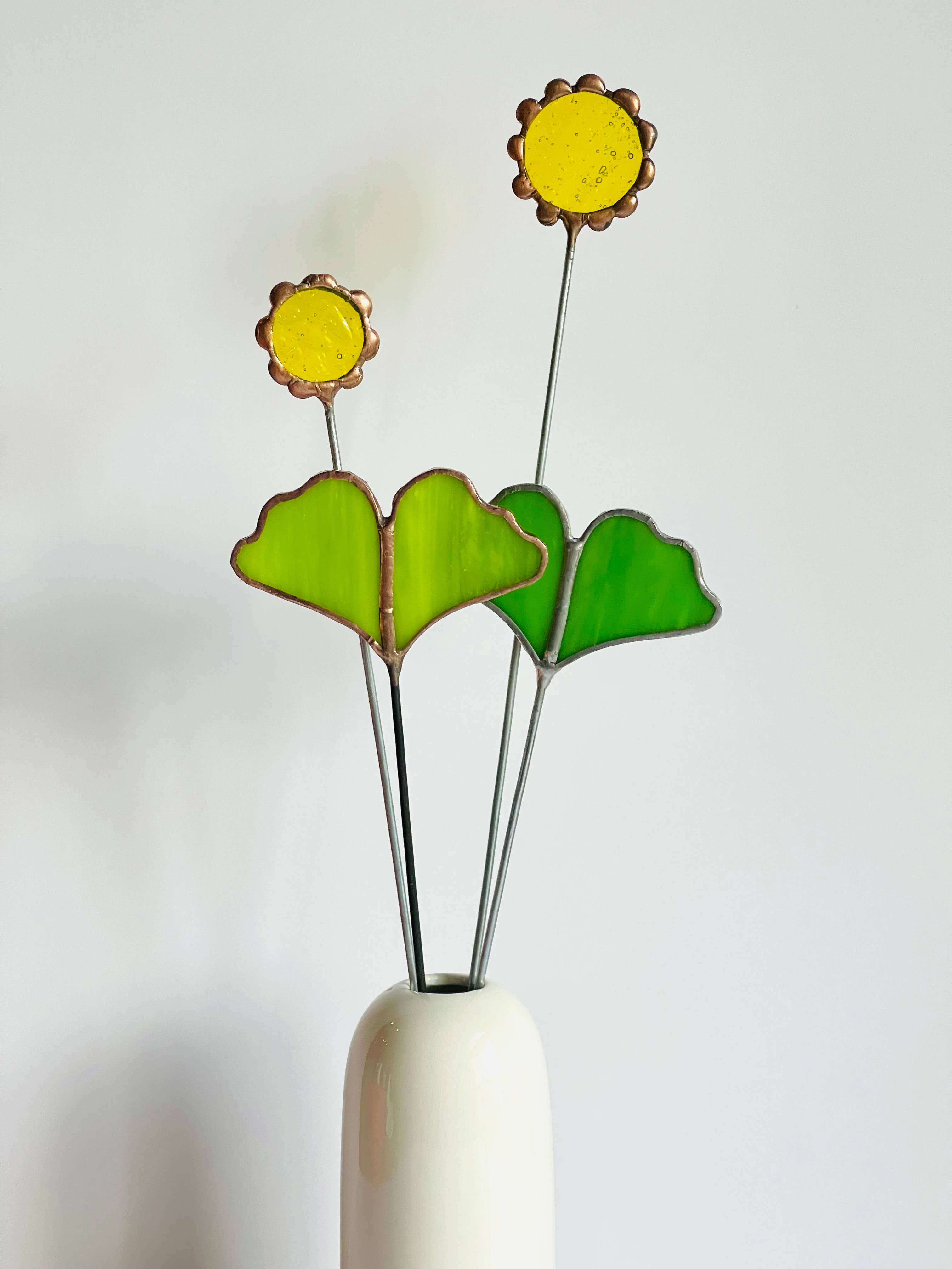 Handmade stained glass buttercups add bright yellow charm to any space. Pet-safe, low-maintenance decor for vases or planters. Set of four stems.