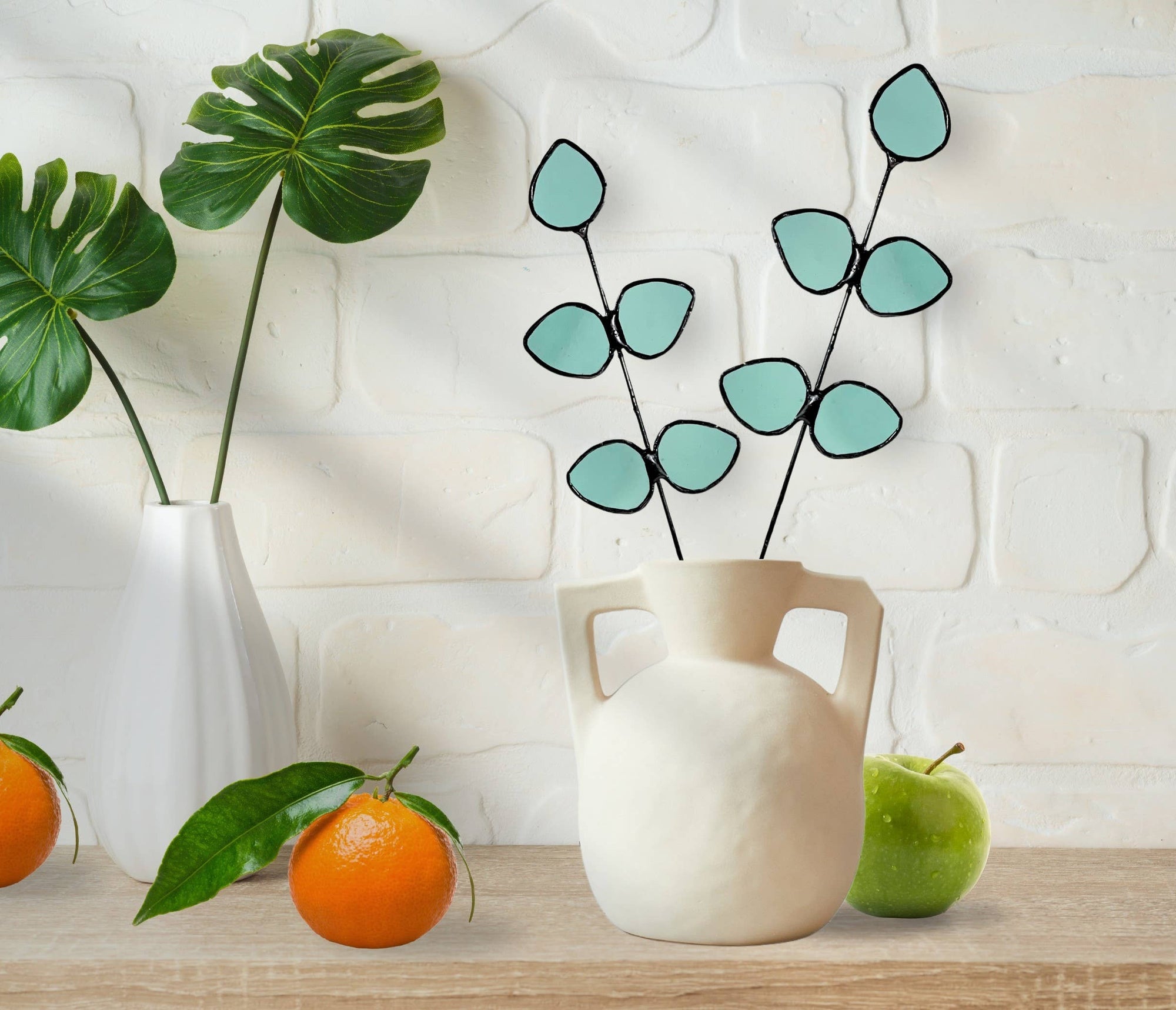 Bring a pop of color and artistry to your home with this handcrafted stained glass gumdrop eucalyptus stem by Samara Designs Studio. This stem is made from beautiful transparent seafoam green stained glass, cut and assembled by hand to create a lasting botanical accent that will never wilt or fade.