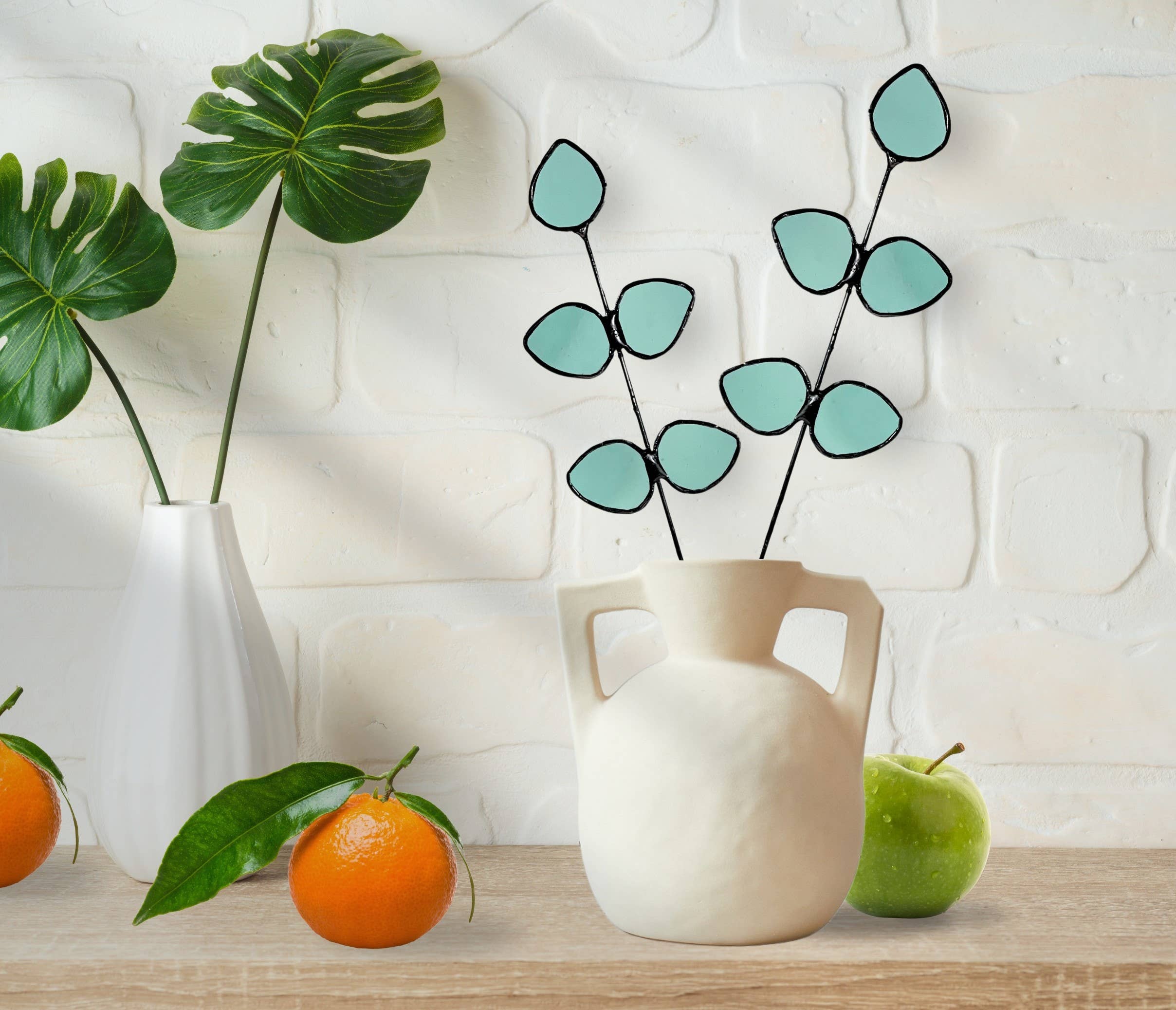 Bring a pop of color and artistry to your home with this handcrafted stained glass gumdrop eucalyptus stem by Samara Designs Studio. This stem is made from beautiful transparent seafoam green stained glass, cut and assembled by hand to create a lasting botanical accent that will never wilt or fade.