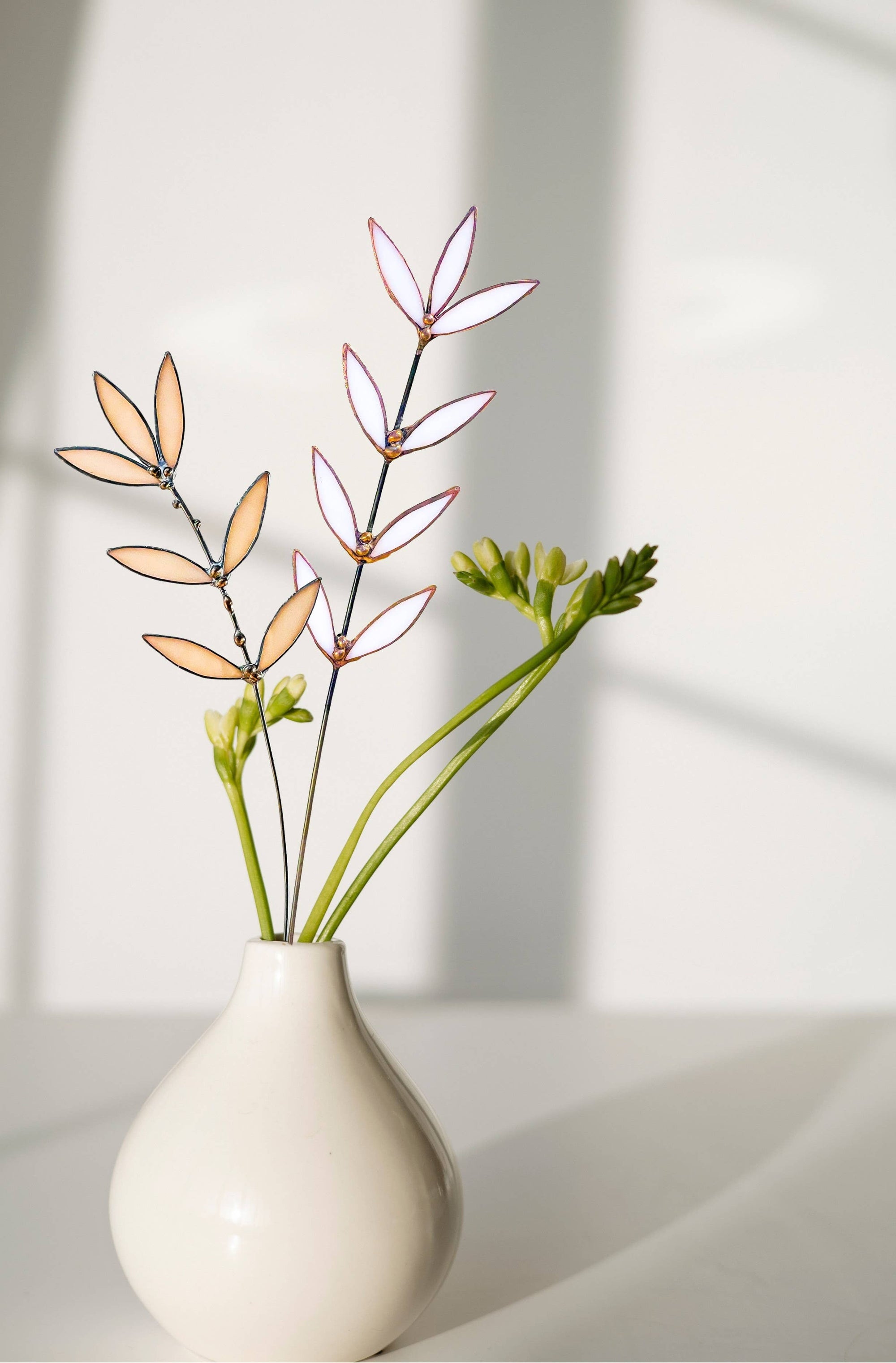 Bring a pop of color and artistry to your home with this handcrafted stained glass peachy pink wildflower by Samara Designs Studio. This delicate sprig is handmade using peachy pink stained glass. Each piece of glass is hand cut and meticulously crafted using the traditional stained glass copper foil technique to create a lasting botanical accent that will never wilt or fade.