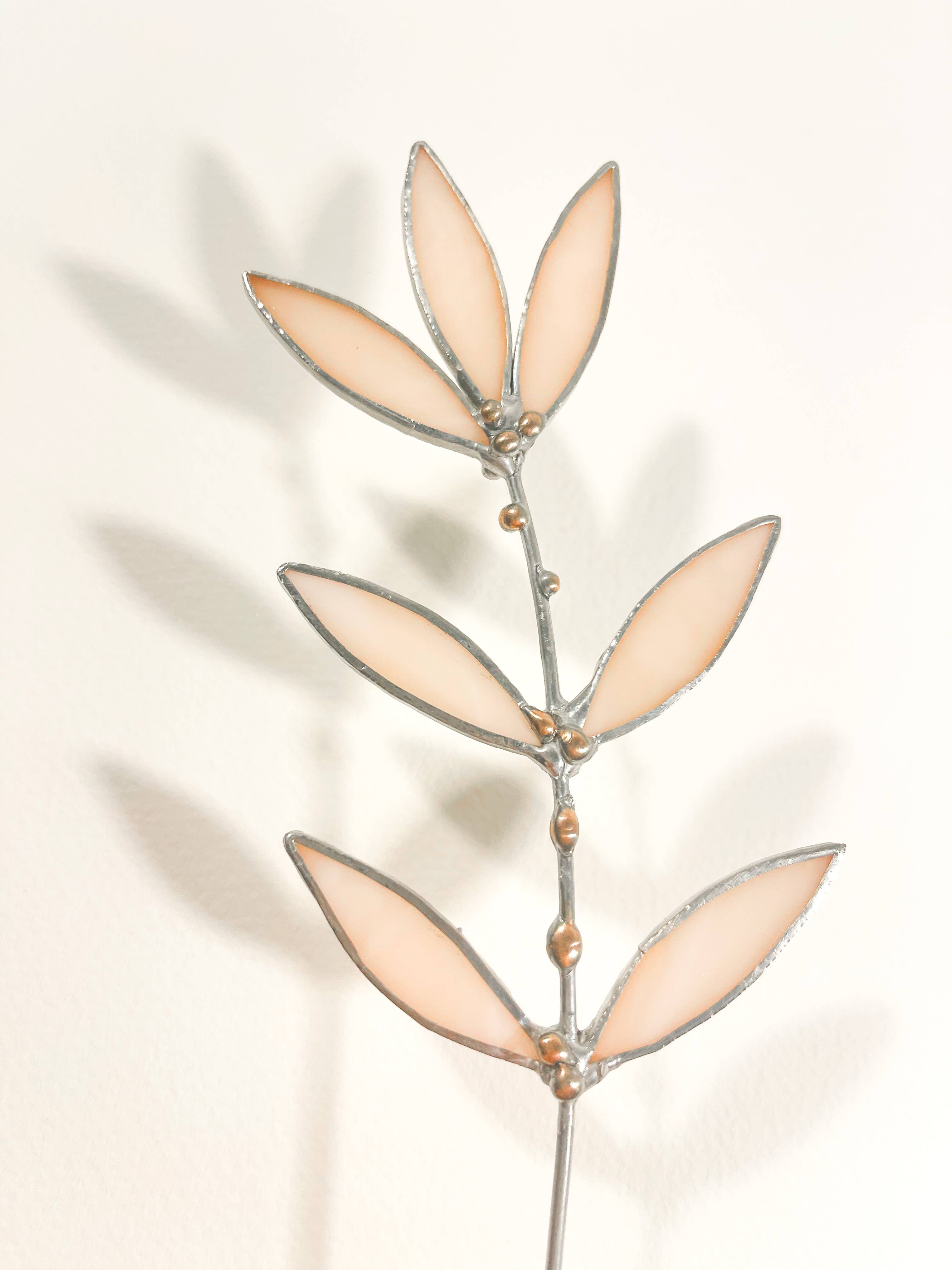 Bring a pop of color and artistry to your home with this handcrafted stained glass peachy pink wildflower by Samara Designs Studio. This delicate sprig is handmade using peachy pink stained glass. Each piece of glass is hand cut and meticulously crafted using the traditional stained glass copper foil technique to create a lasting botanical accent that will never wilt or fade.