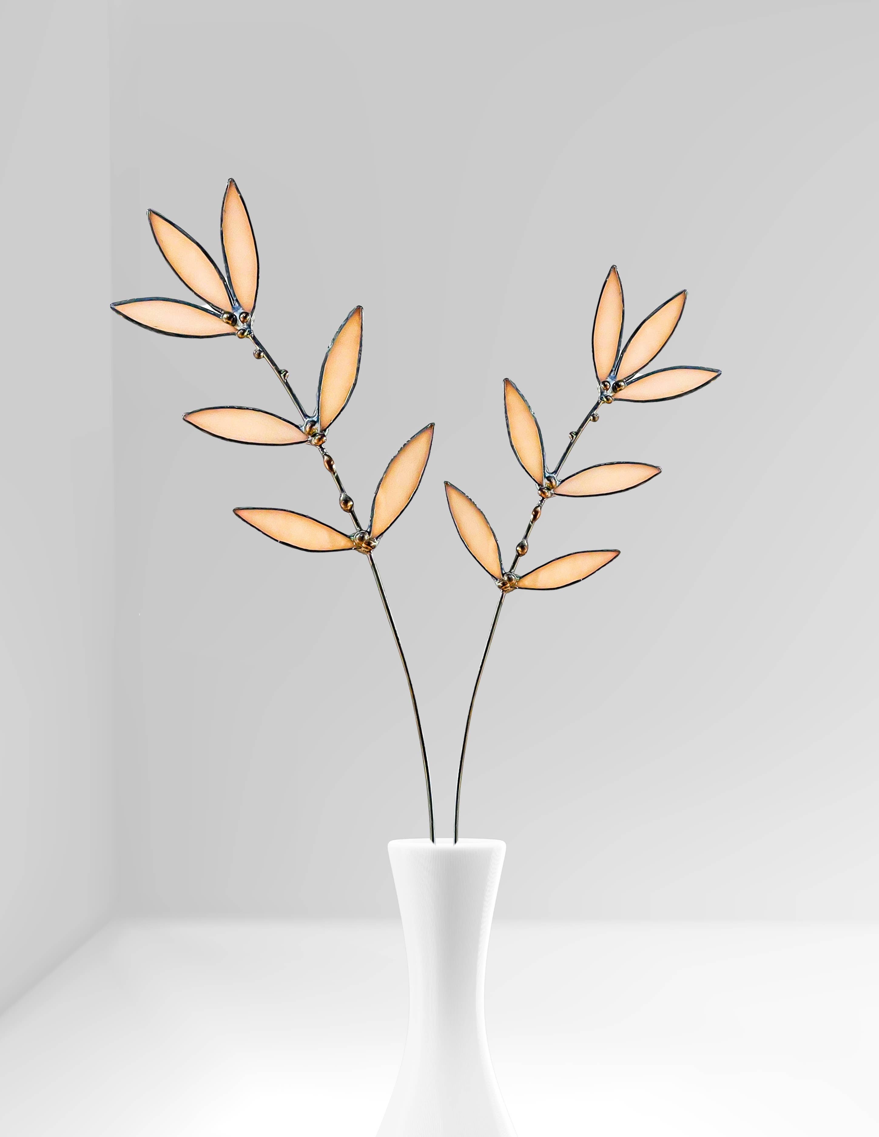 Bring a pop of color and artistry to your home with this handcrafted stained glass peachy pink wildflower by Samara Designs Studio. This delicate sprig is handmade using peachy pink stained glass. Each piece of glass is hand cut and meticulously crafted using the traditional stained glass copper foil technique to create a lasting botanical accent that will never wilt or fade.