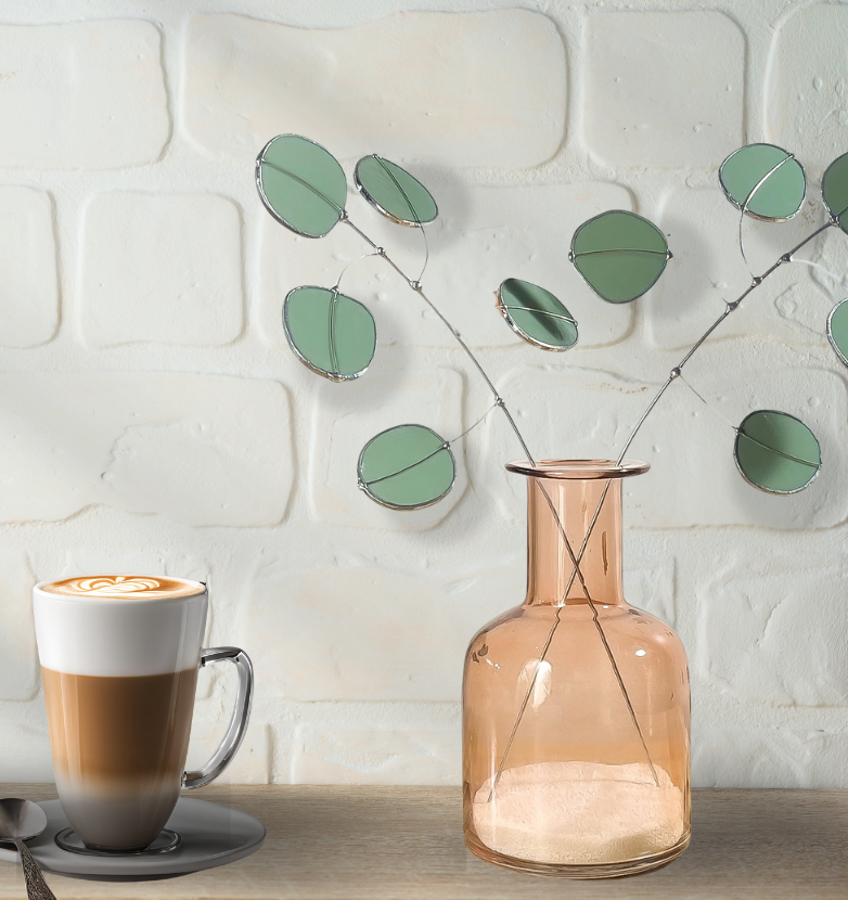 Bring a pop of color and artistry to your home with this handcrafted stained glass silver dollar eucalyptus stem by Samara Designs Studio. This stem is made from beautiful celadon green stained glass, carefully cut and assembled by hand to create a lasting botanical accent that will never wilt or fade.